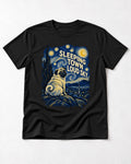 Pug Sleeping Town Loud Sky Starry Night Graphic T-Shirt in Black, flat lay product photo