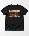 Rottweiler Balance Is Built Resting Strength Graphic T-Shirt in Black, flat lay product photo