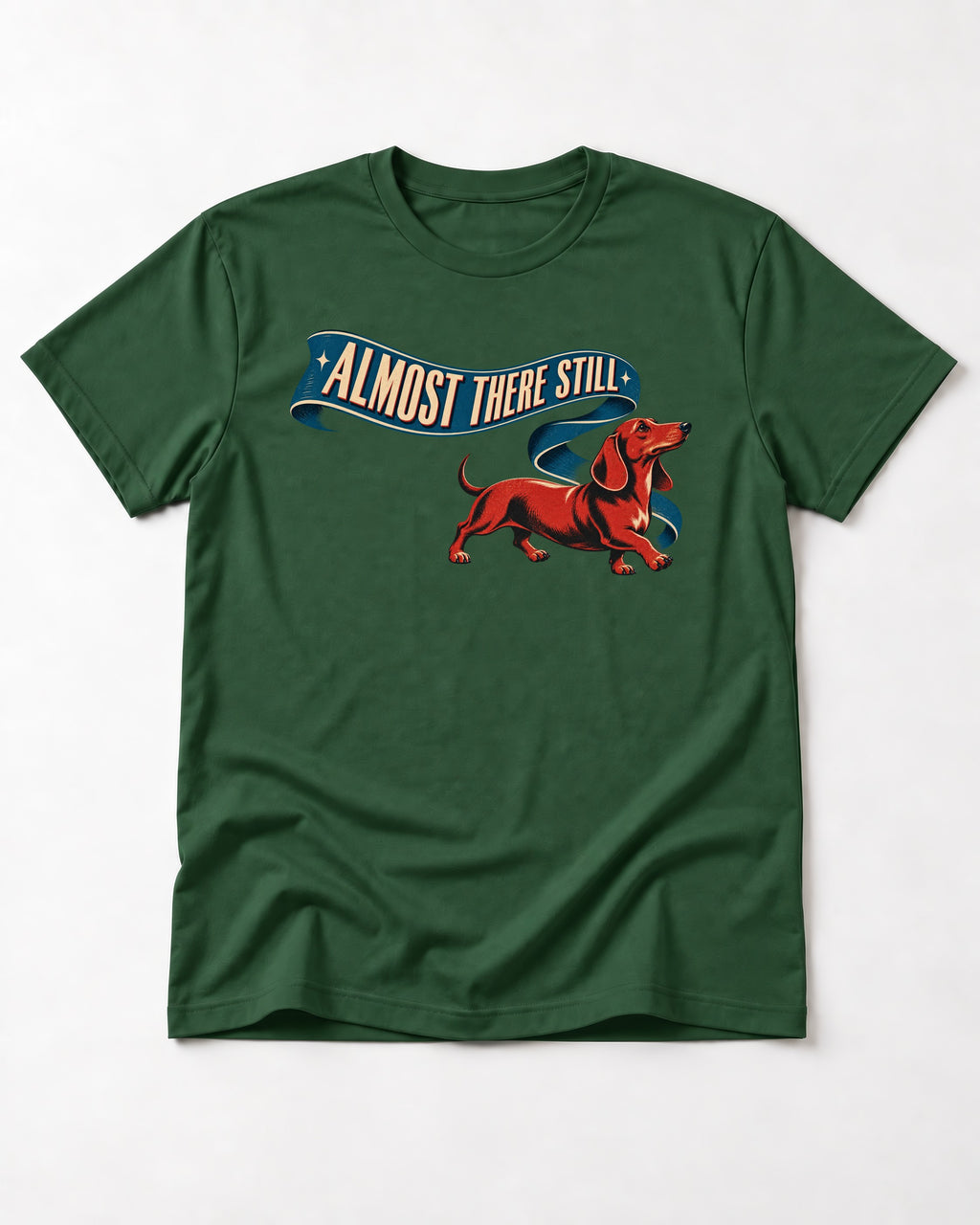 Dachshund Almost There Still Ribbon Graphic T-Shirt in Forest Green, flat lay product photo