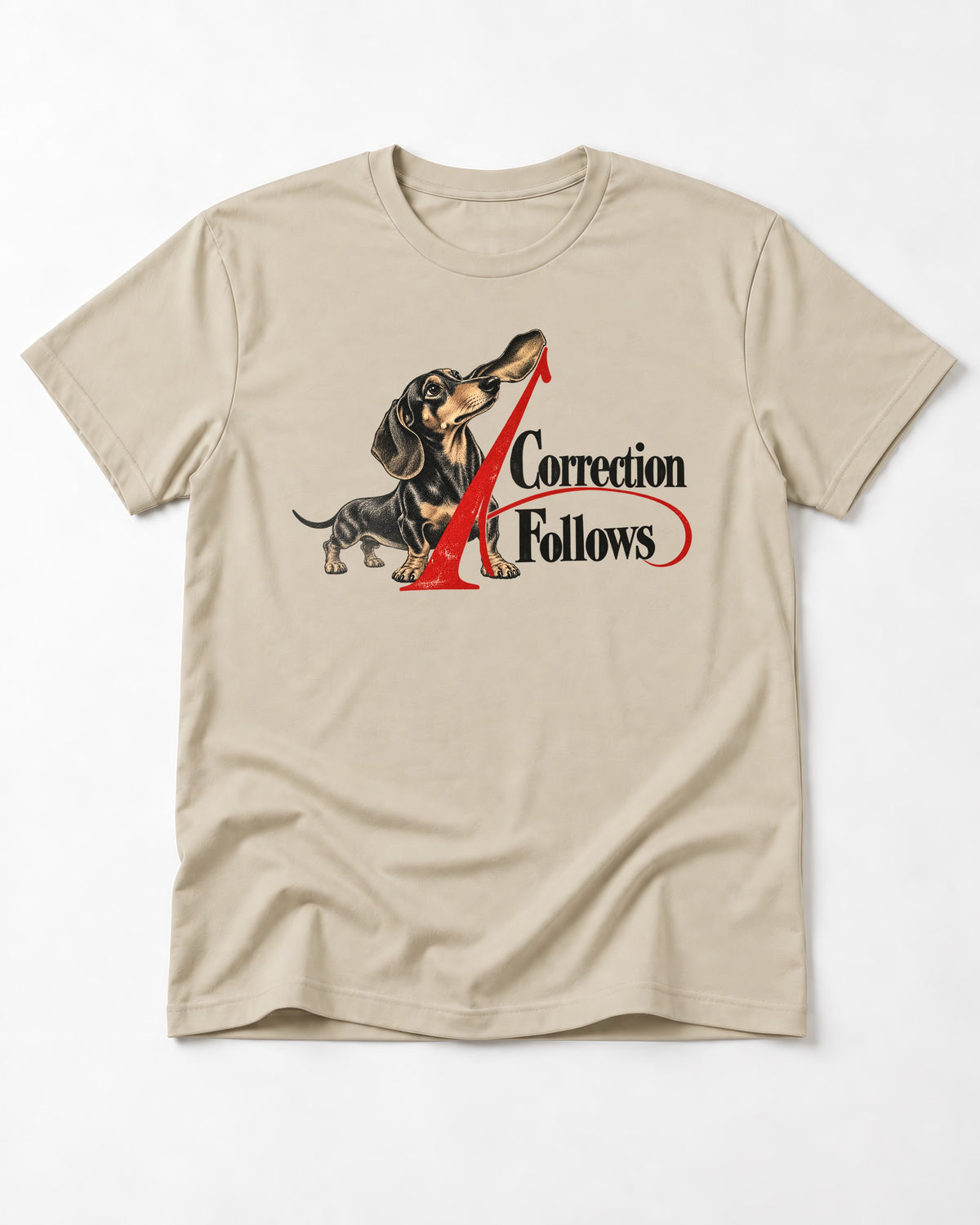 A Dachshund Correction Follows T-Shirt in Sand, flat lay product photo