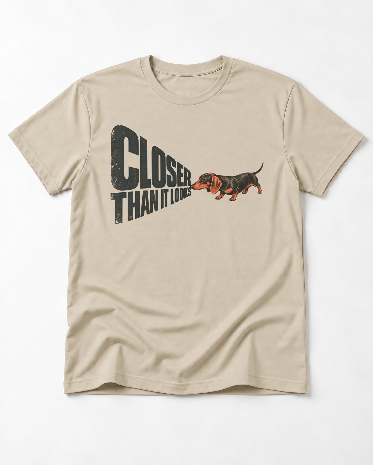 Dachshund Closer Than It Looks T-Shirt in Sand, flat lay product photo