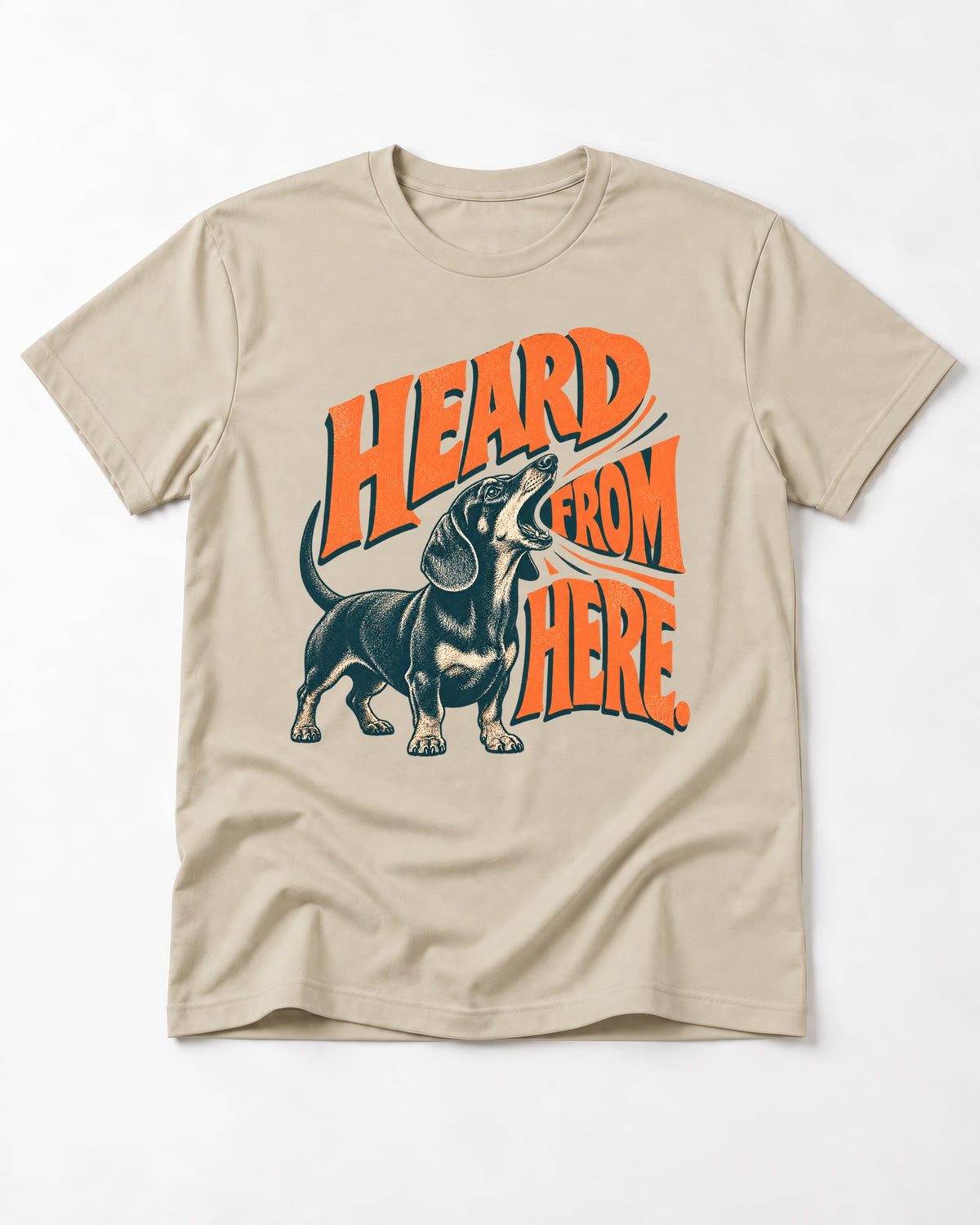 Dachshund Heard From Here T-Shirt in Sand, flat lay product photo