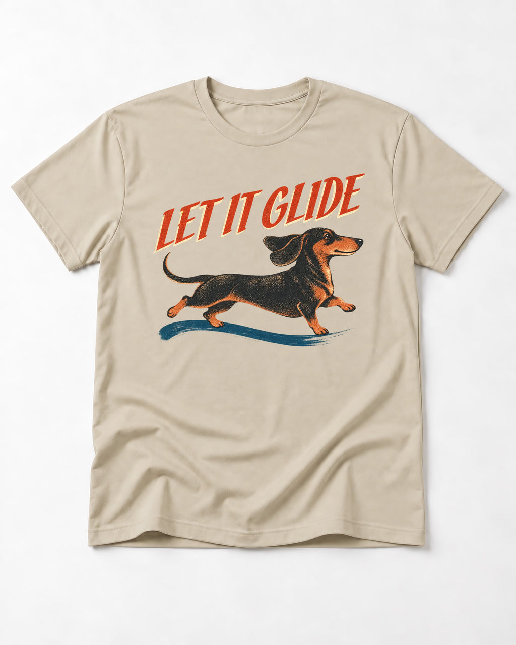 Let It Glide Dachshund T-Shirt in Sand, flat lay product photo