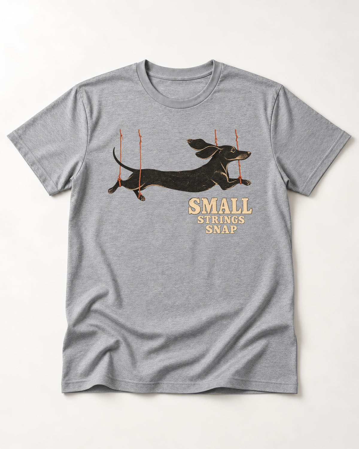 Dachshund Small Strings Snap Marionette Graphic T-Shirt in Sport Grey, flat lay product photo