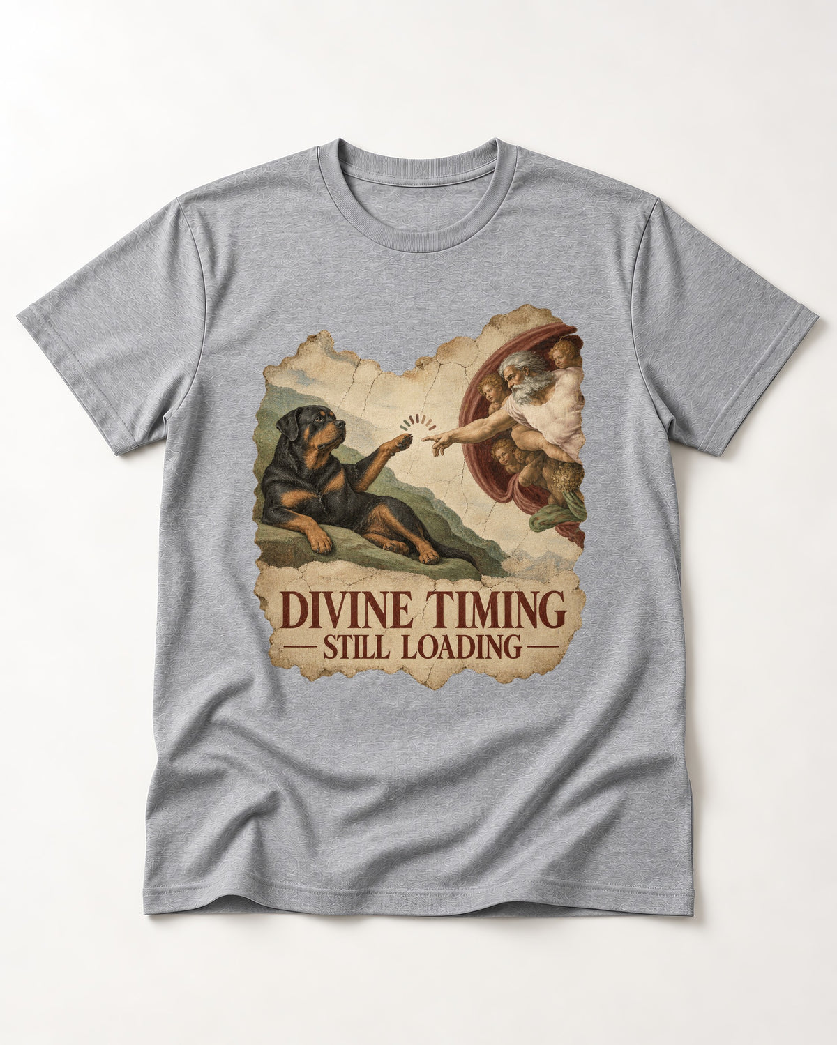 Rottweiler Divine Timing Still Loading Creation Parody Graphic T-Shirt in Sport Grey, flat lay product photo