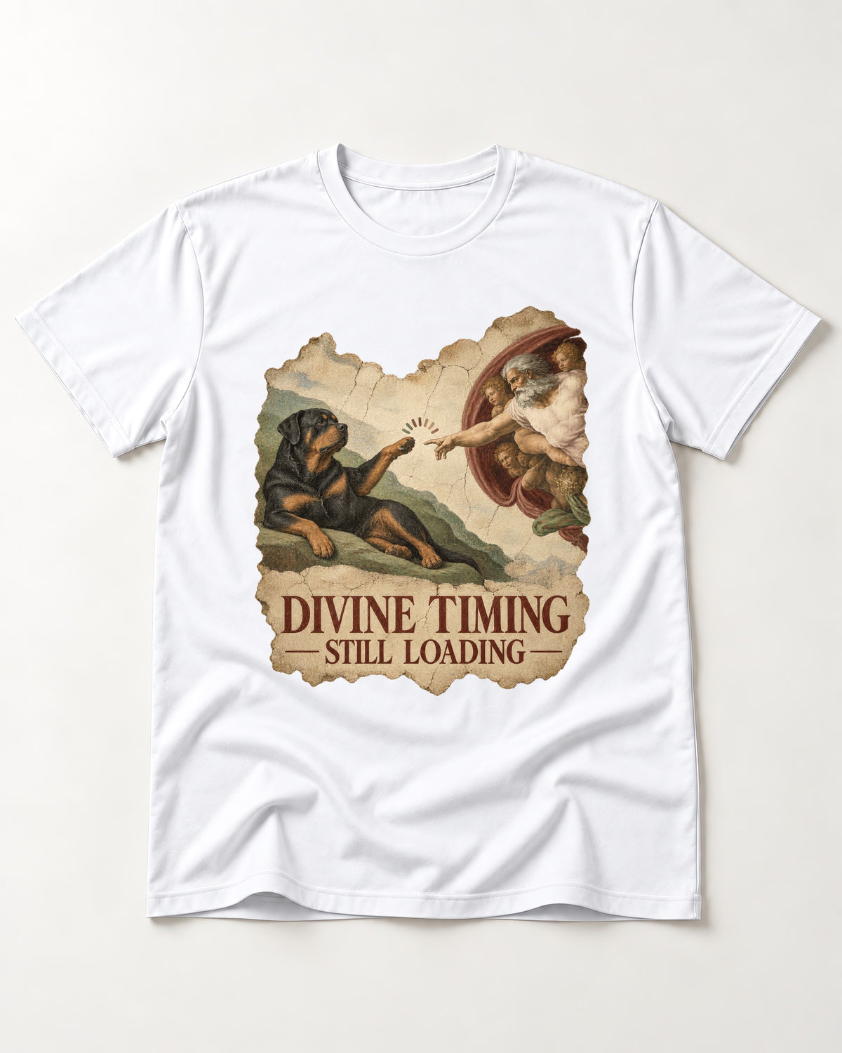 Rottweiler Divine Timing Still Loading Creation Parody Graphic T-Shirt in White, flat lay product photo