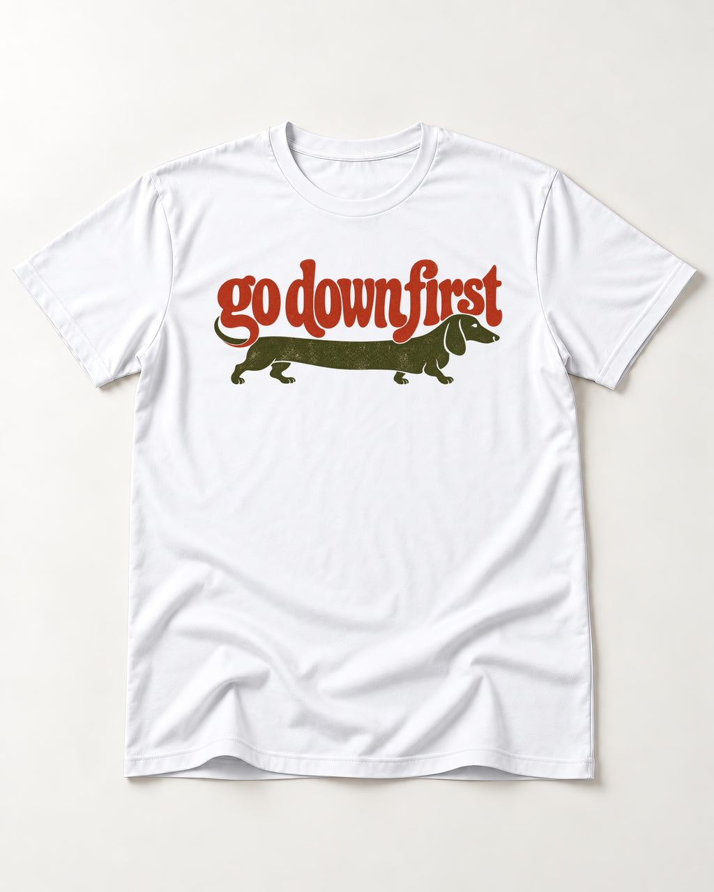 Dachshund Goes Down First T-Shirt in White, flat lay product photo