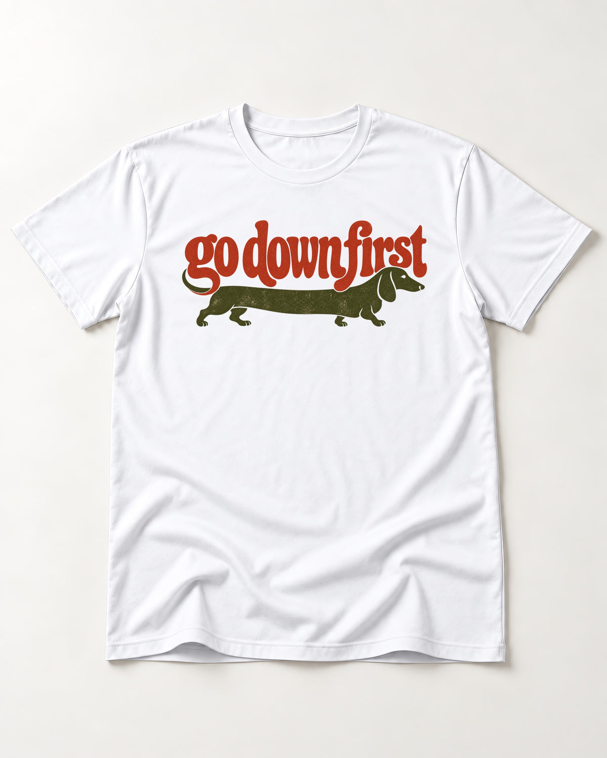 Dachshund Goes Down First T-Shirt in White, flat lay product photo