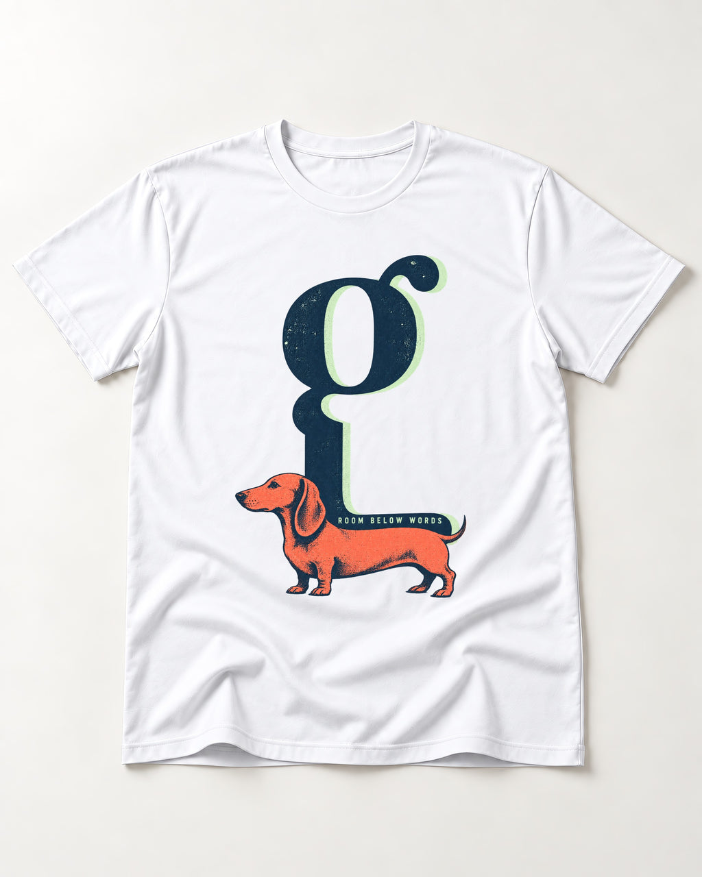 Dachshund Room Below Words Lowercase G Graphic T-Shirt in White, flat lay product photo
