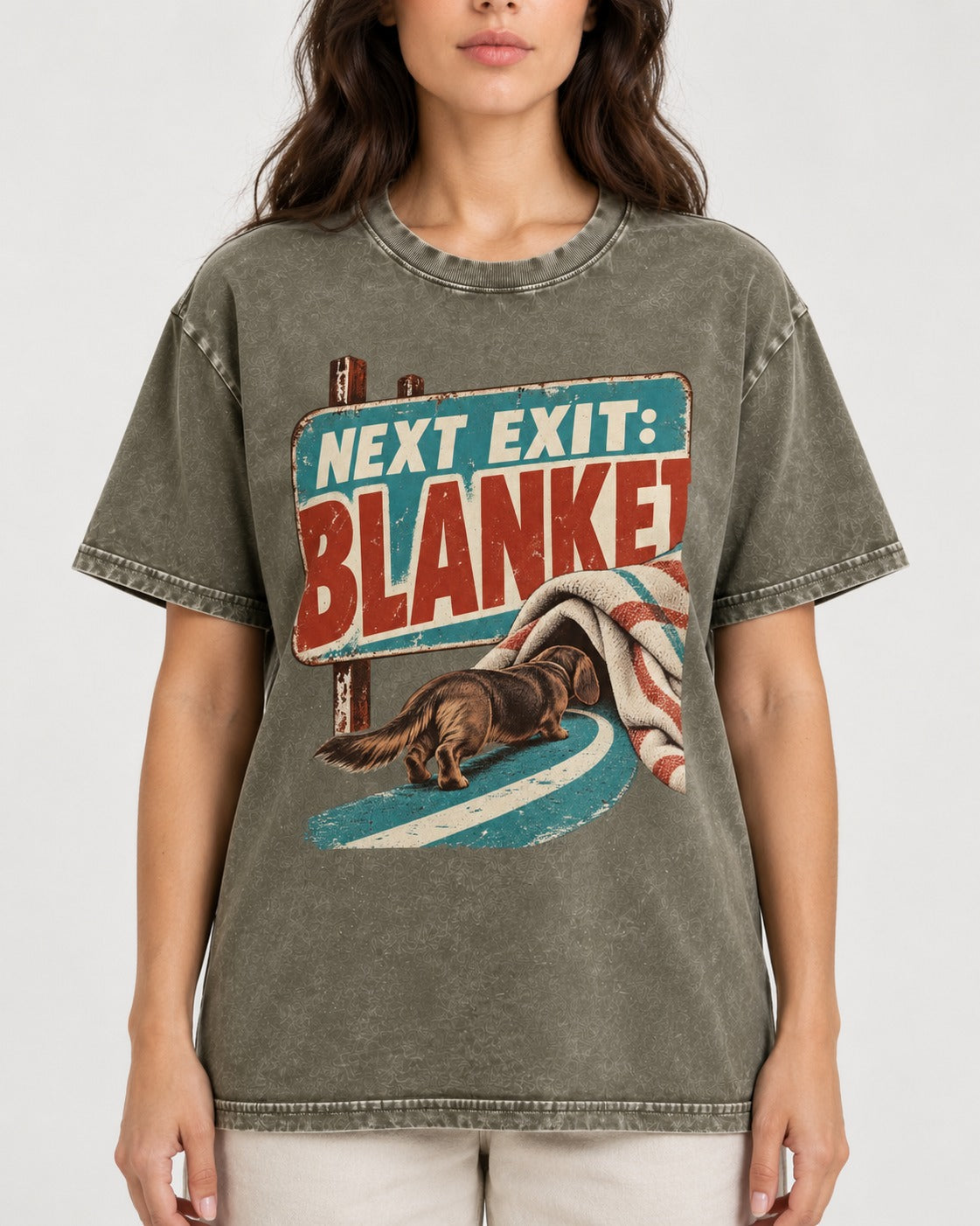 Dachshund Next Exit Blanket Road Sign Graphic Washed Tee in Army Green, worn by a model, front view