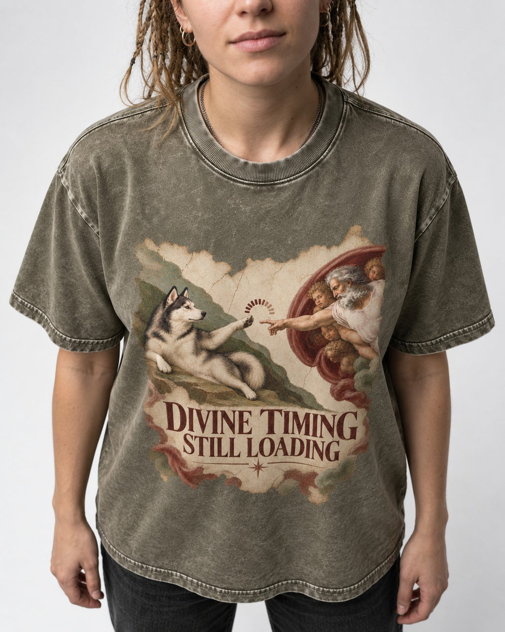 Husky Divine Timing Still Loading Creation Parody Graphic Washed Tee in Army Green, worn by a model, front view