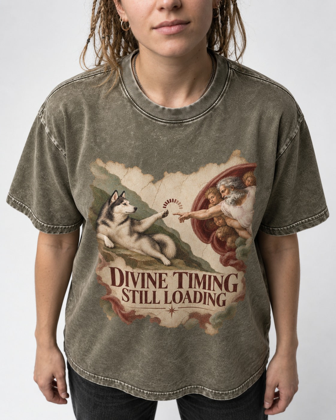 Husky Divine Timing Still Loading Creation Parody Graphic Washed Tee in Army Green, worn by a model, front view