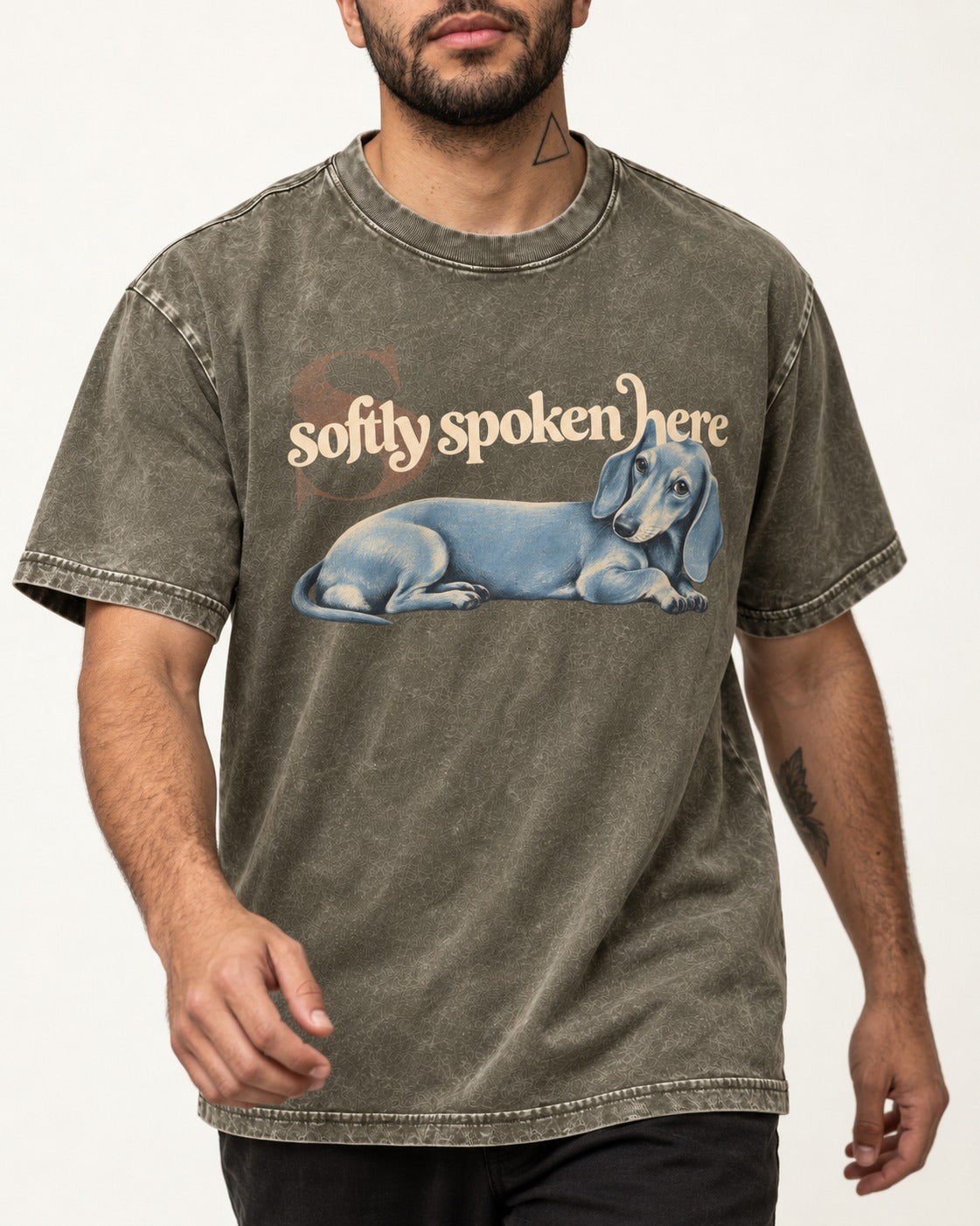 Dachshund Softly Spoken Here Reclining Portrait Graphic Washed Tee in Army Green, worn by a model, front view