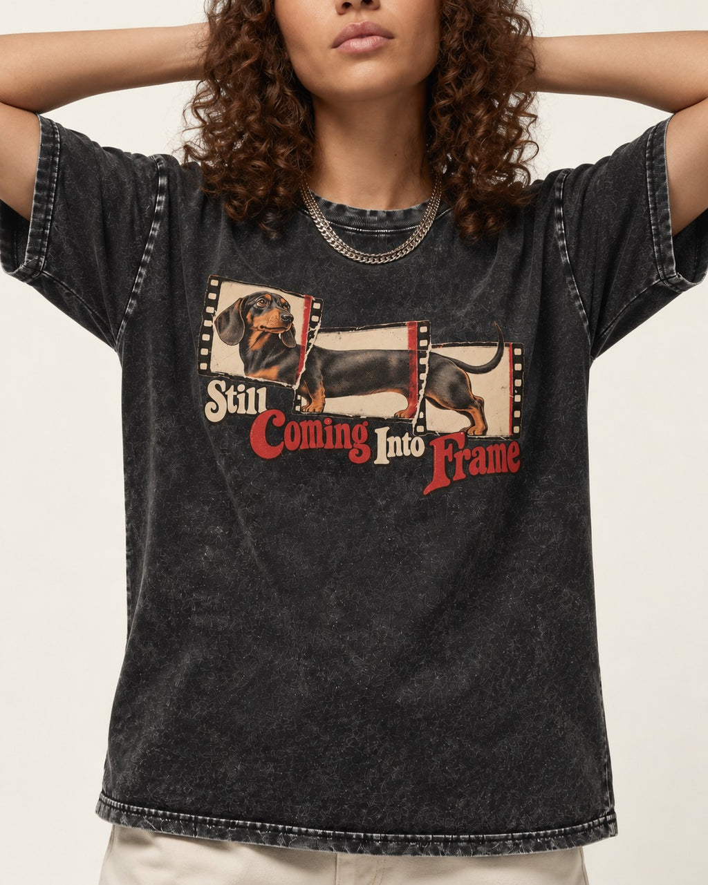 Dachshund Still Coming Into Frame Vintage Filmstrip Graphic Washed Tee in Black, worn by a model, front view