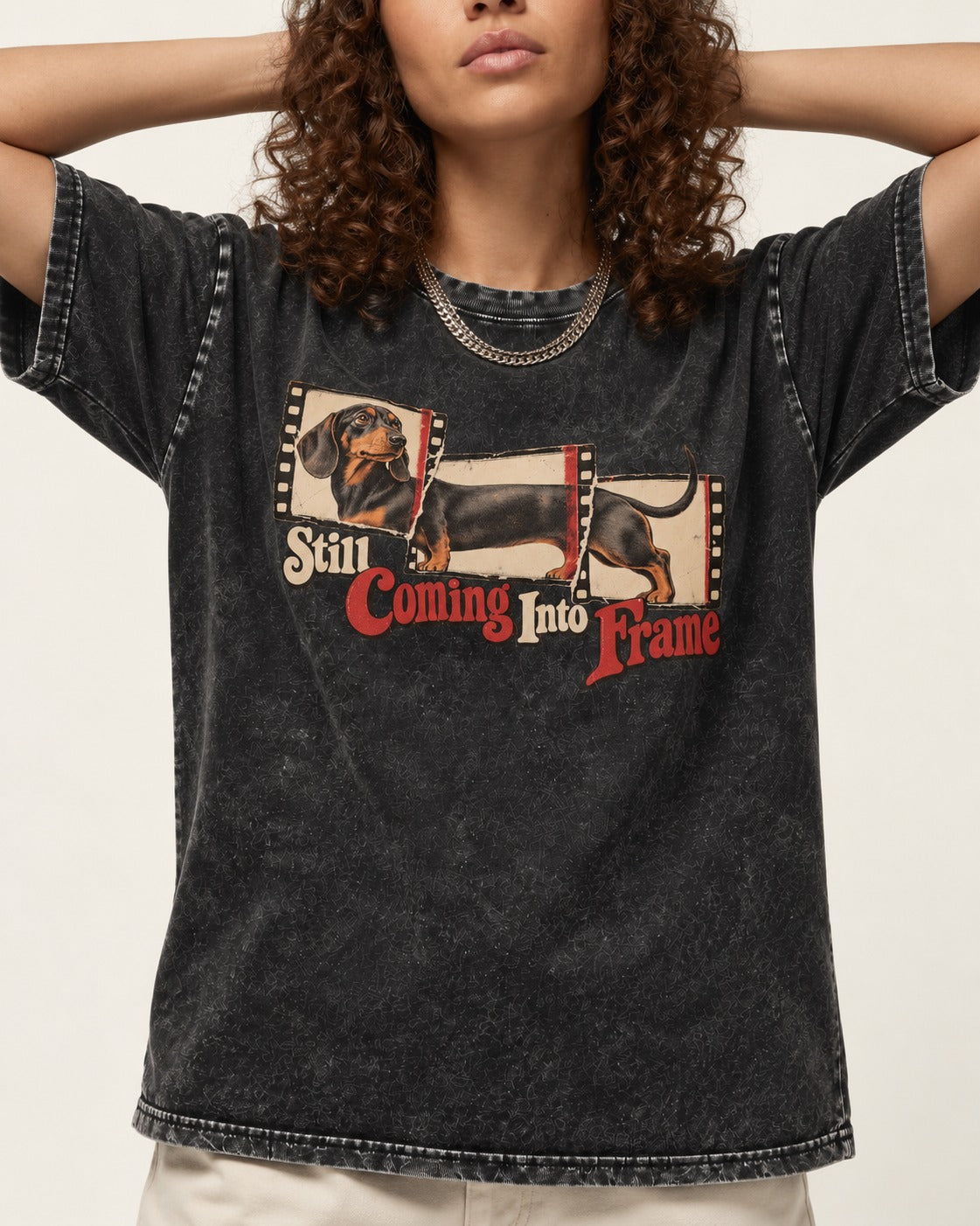 Dachshund Still Coming Into Frame Vintage Filmstrip Graphic Washed Tee in Black, worn by a model, front view