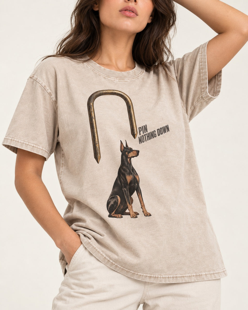 Nothing Pins Doberman Down Washed Tee in Apricot, worn by a model, front view