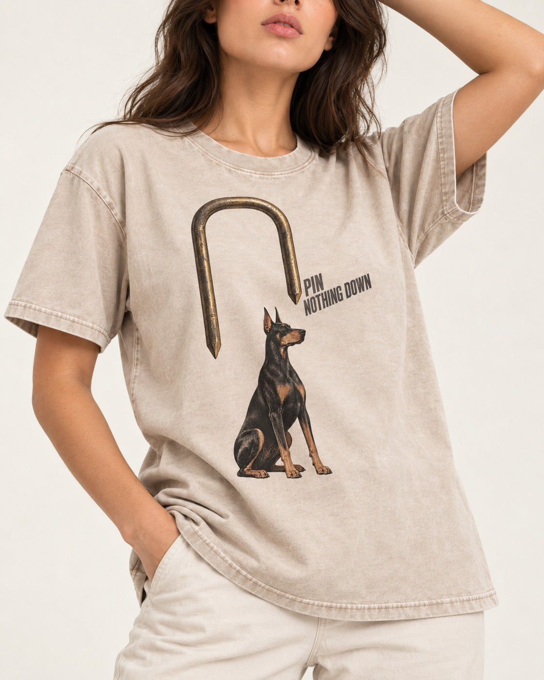 Nothing Pins Doberman Down Washed Tee in Apricot, worn by a model, front view