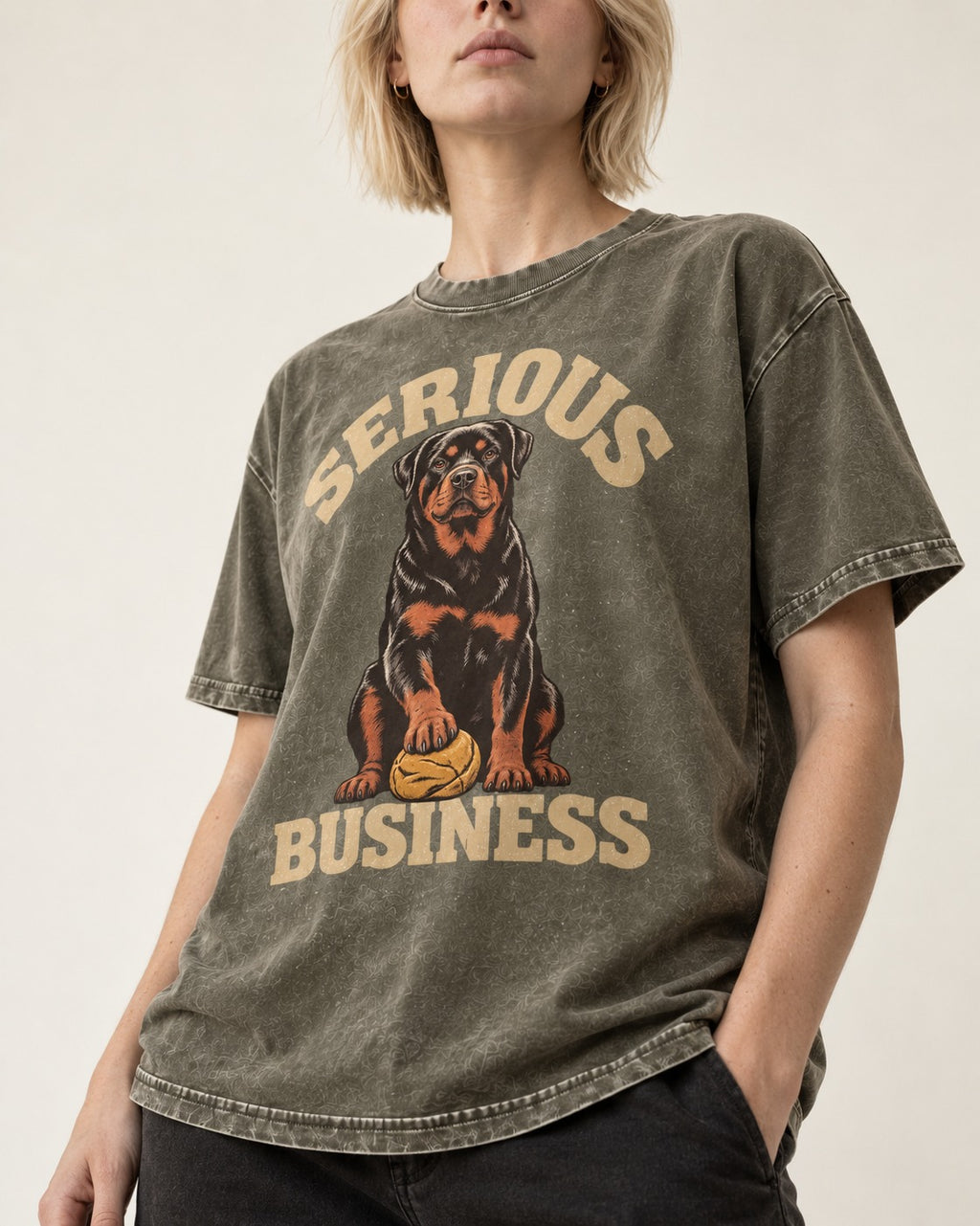 Rottweiler Serious Business Ball Under Paw Graphic Washed Tee in Army Green, worn by a model, front view
