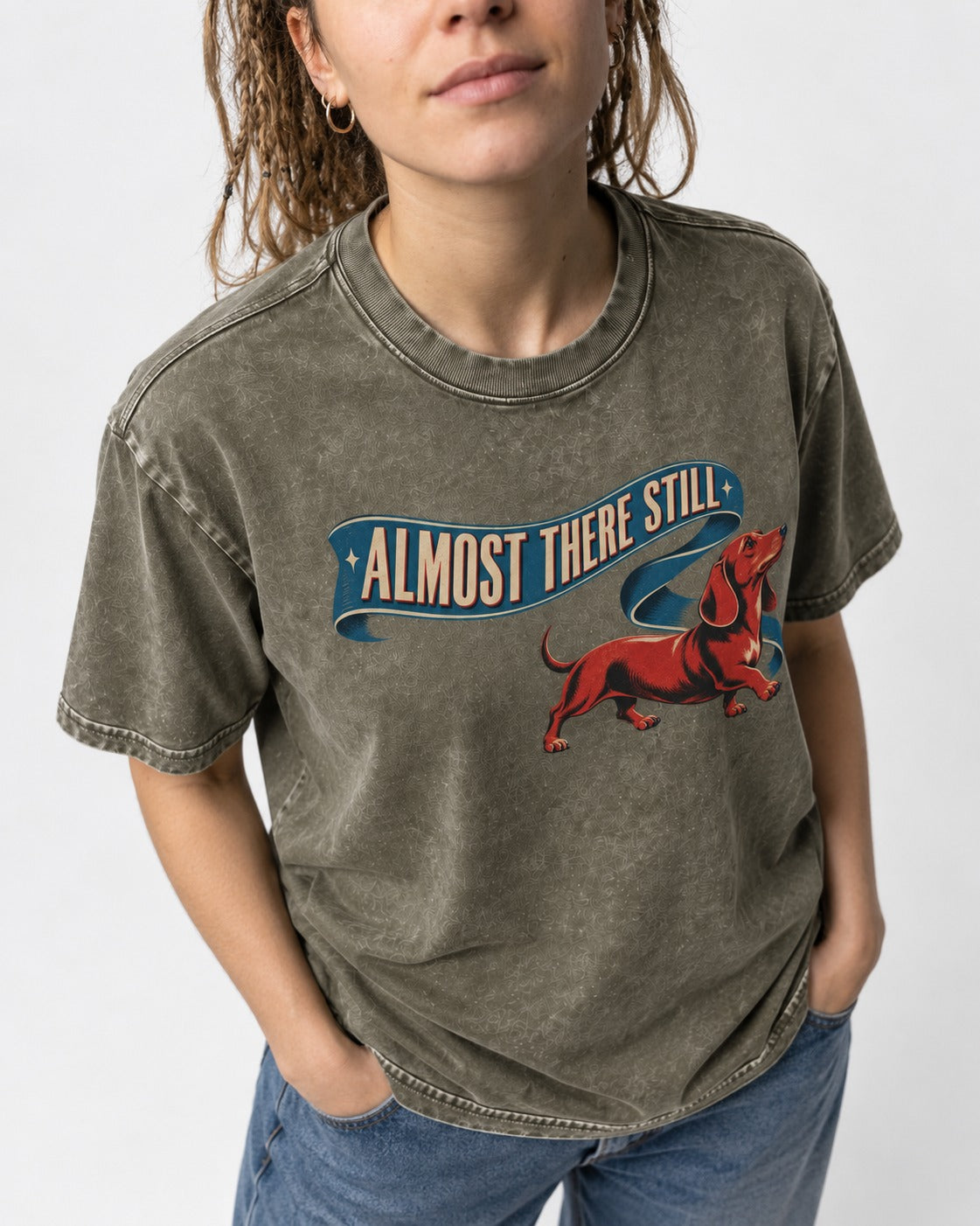Dachshund Almost There Still Ribbon Graphic Washed Tee in Army Green, worn by a model, front view