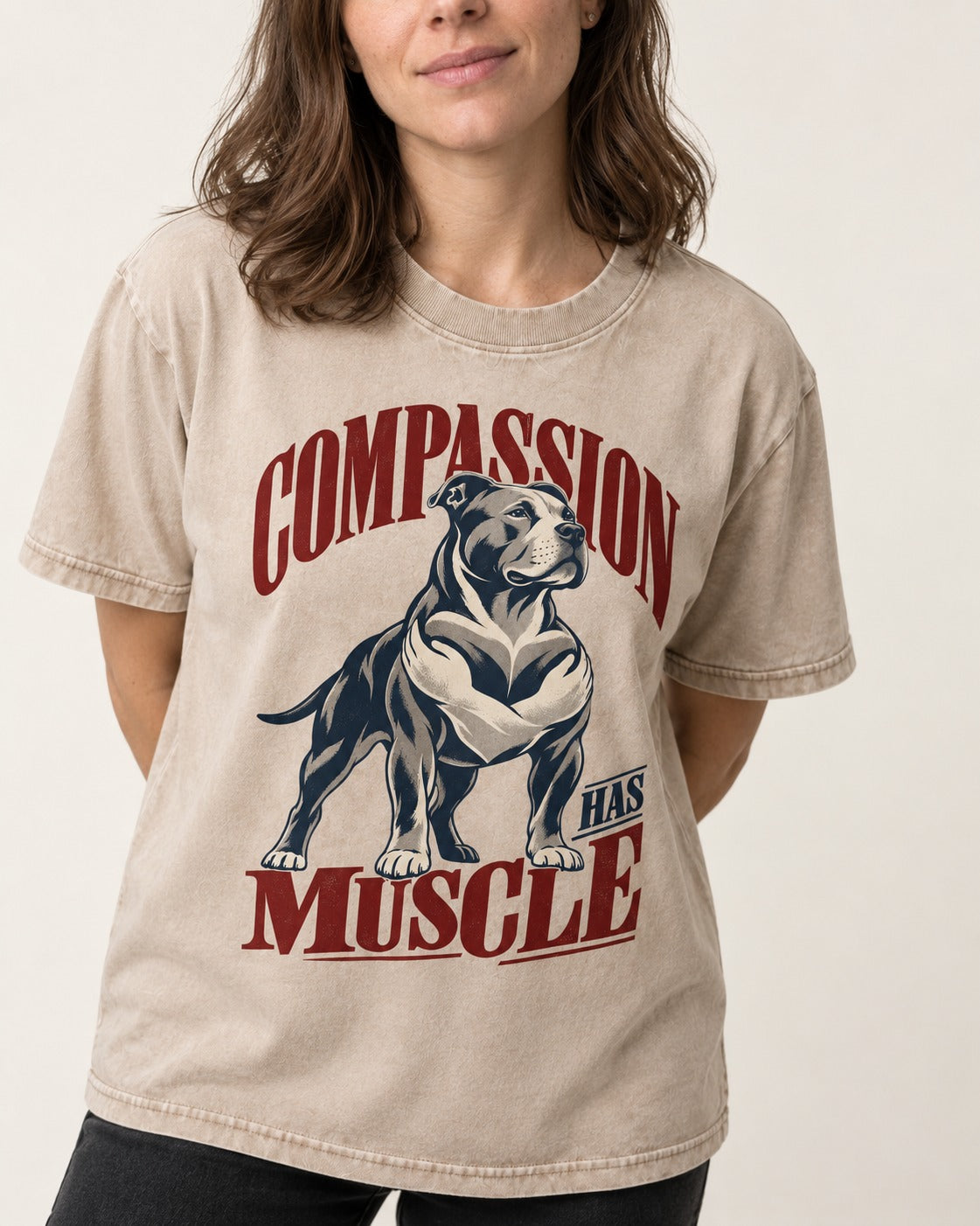 Pitbull Compassion Has Muscle Washed Tee in Apricot, worn by a model, front view