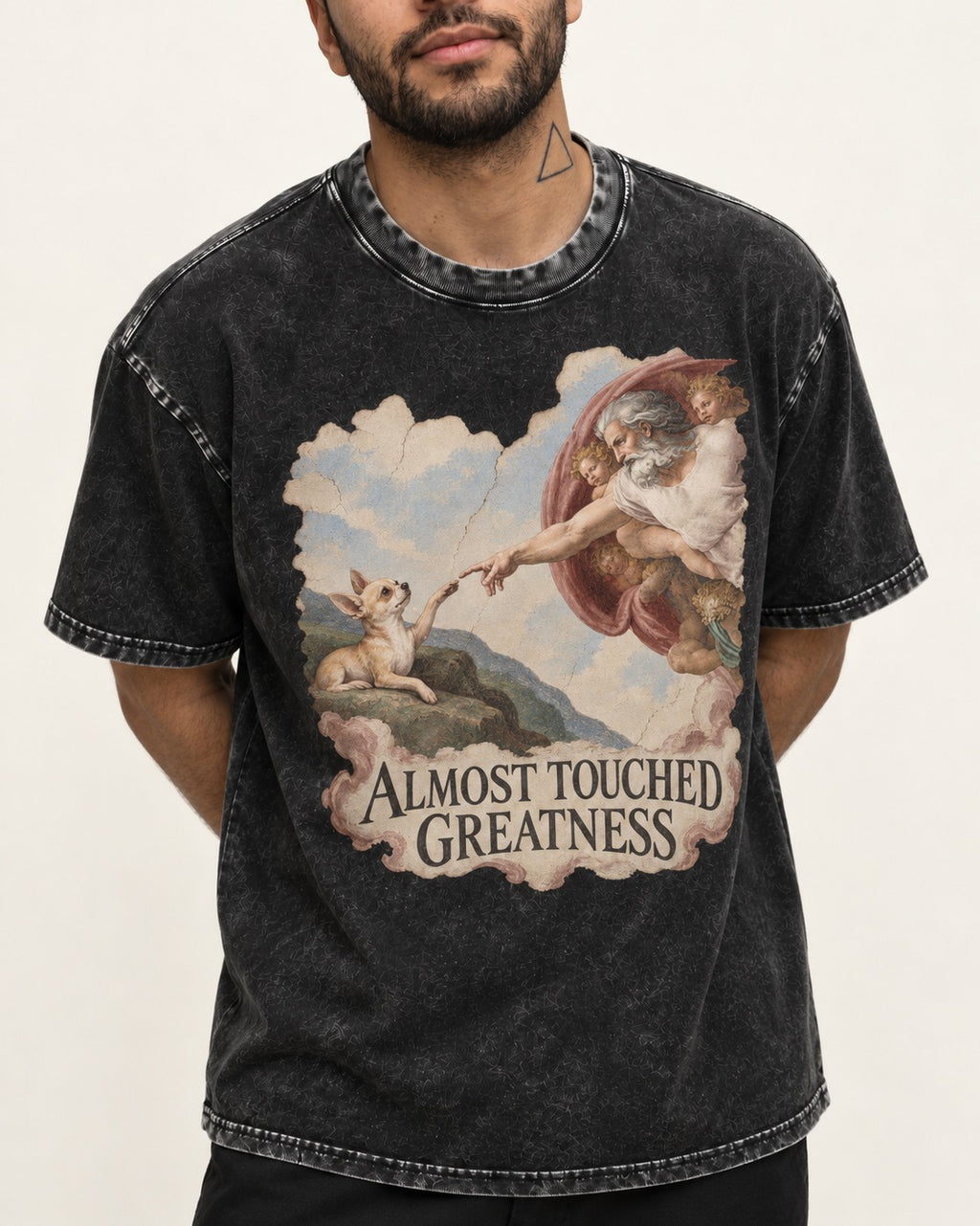 Chihuahua Almost Touched Greatness Renaissance Parody Washed Tee in Black, worn by a model, front view