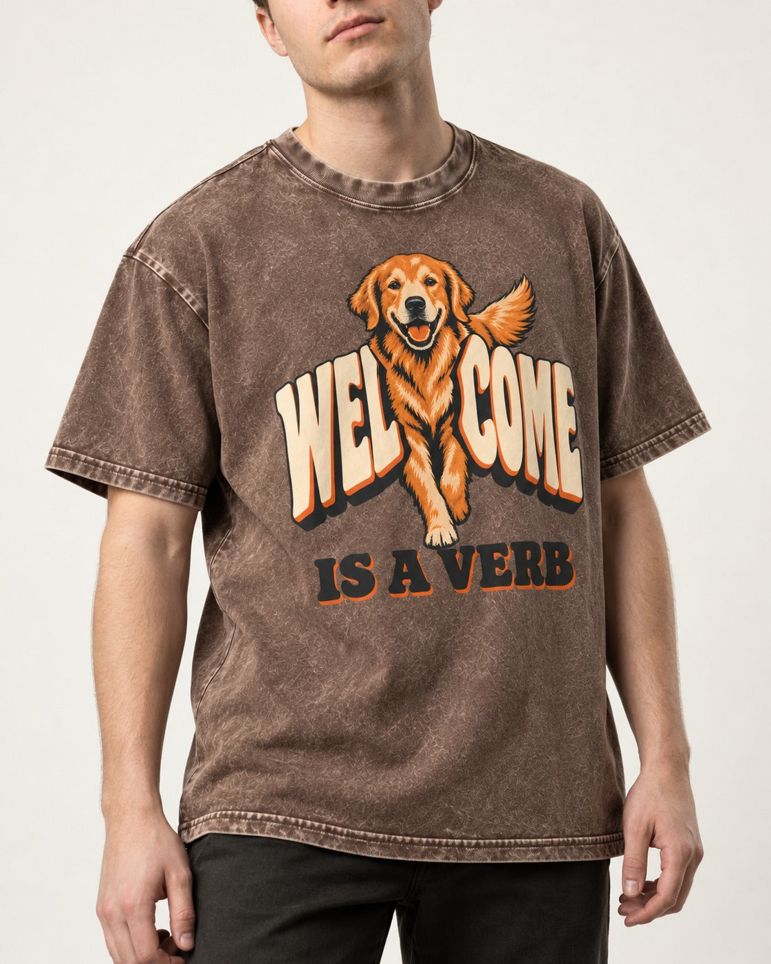 Golden Retriever Welcome Is a Verb Washed Tee in Coffee, worn by a model, front view
