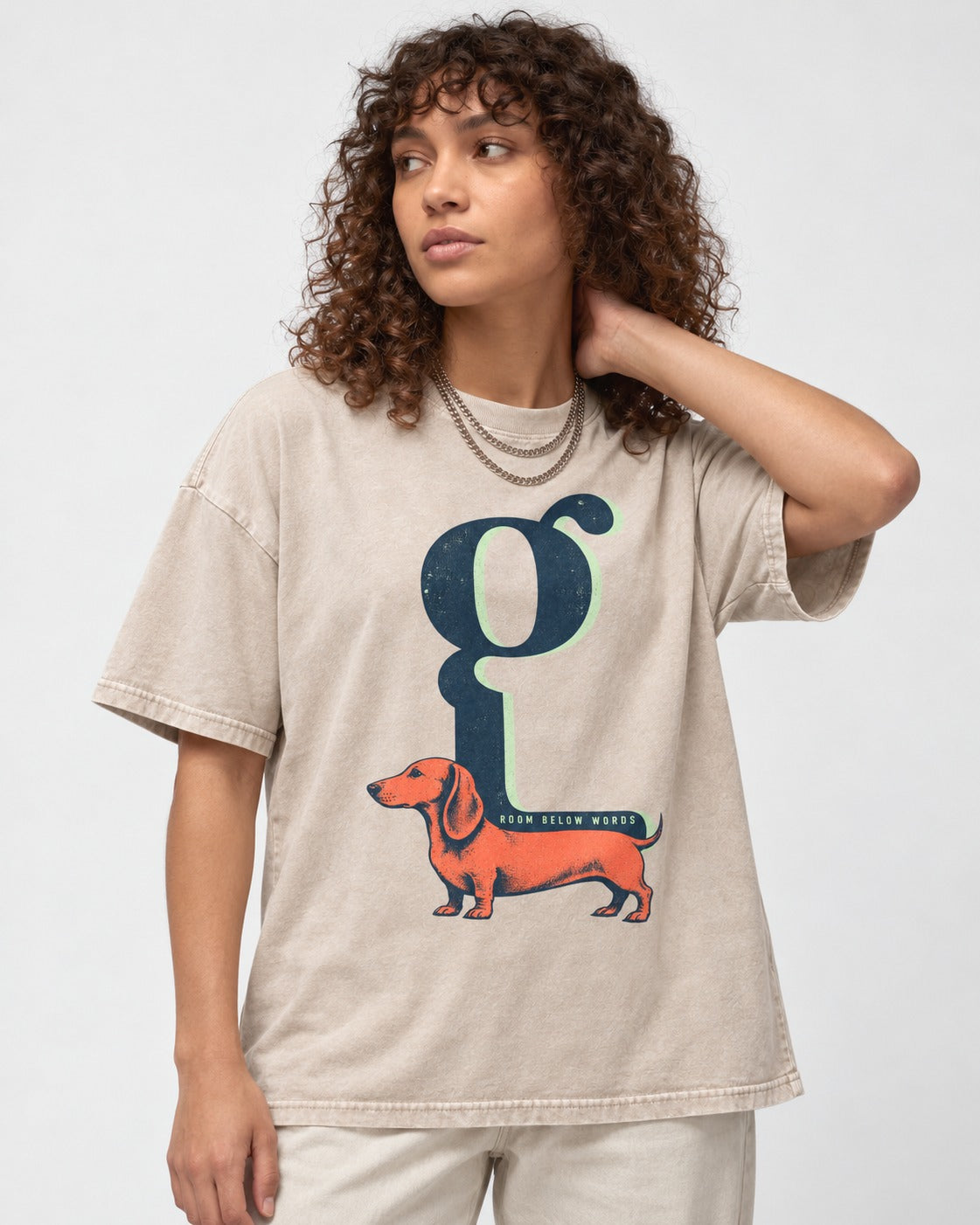 Dachshund Room Below Words Lowercase G Graphic Washed Tee in Apricot, worn by a model