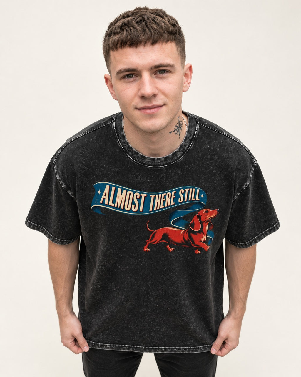 Dachshund Almost There Still Ribbon Graphic Washed Tee in Black, worn by a model