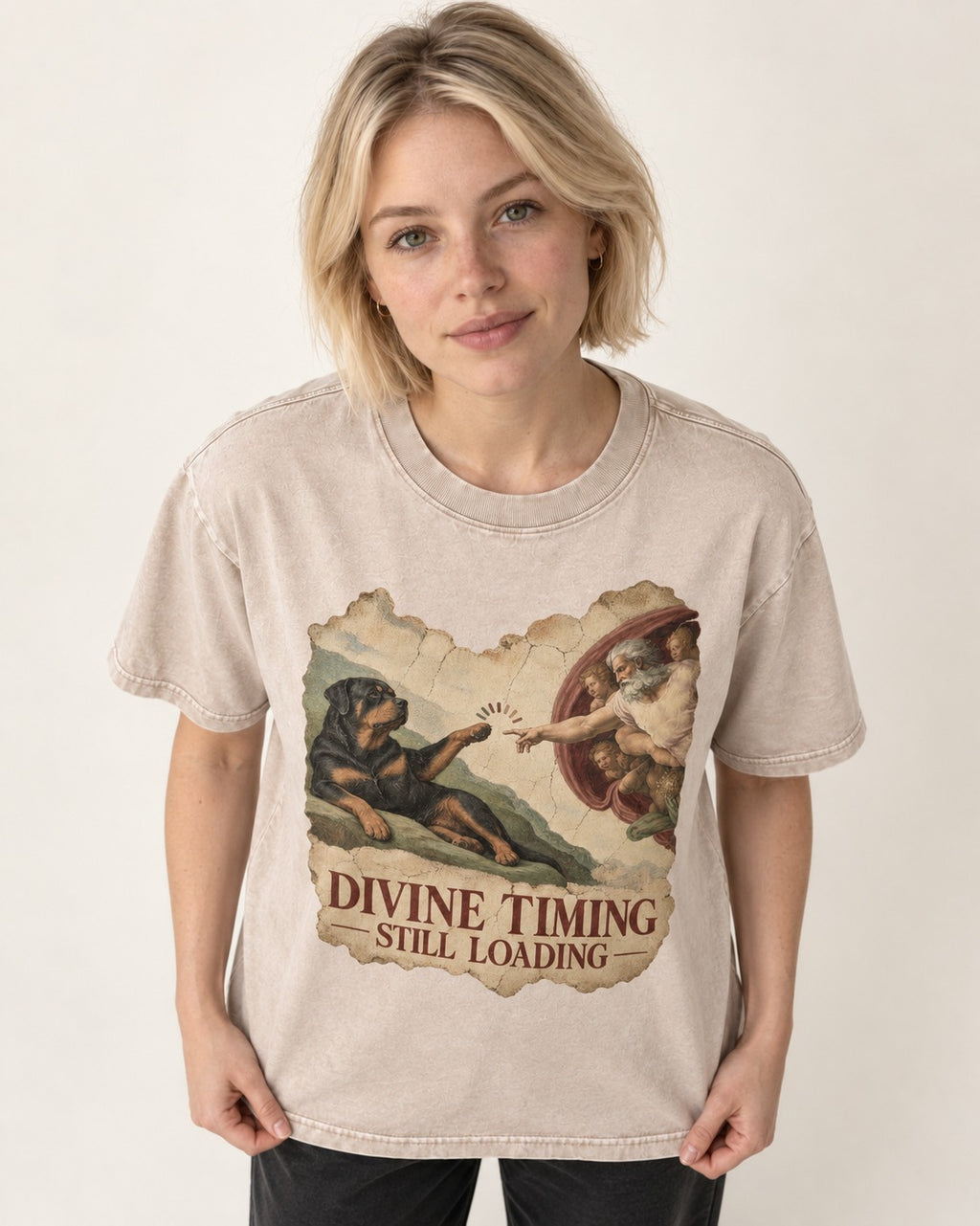 Rottweiler Divine Timing Still Loading Creation Parody Graphic Washed Tee in Apricot, worn by a model
