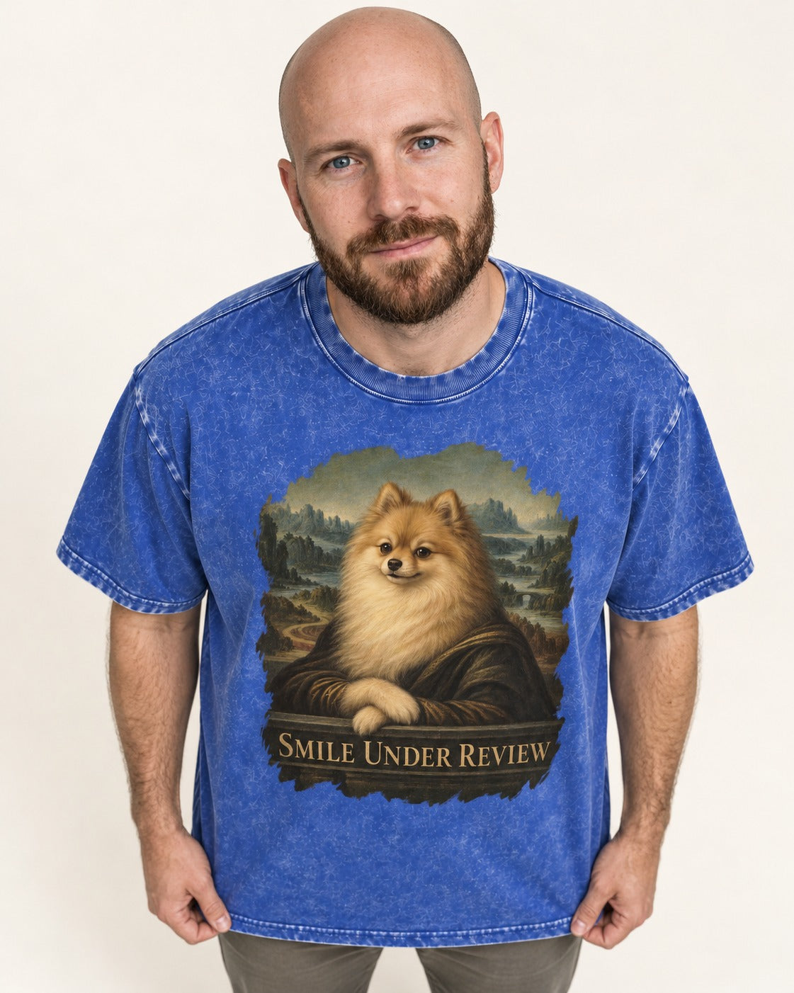 Pomeranian Smile Under Review Renaissance Portrait Graphic Washed Tee in Royal Blue, worn by a model
