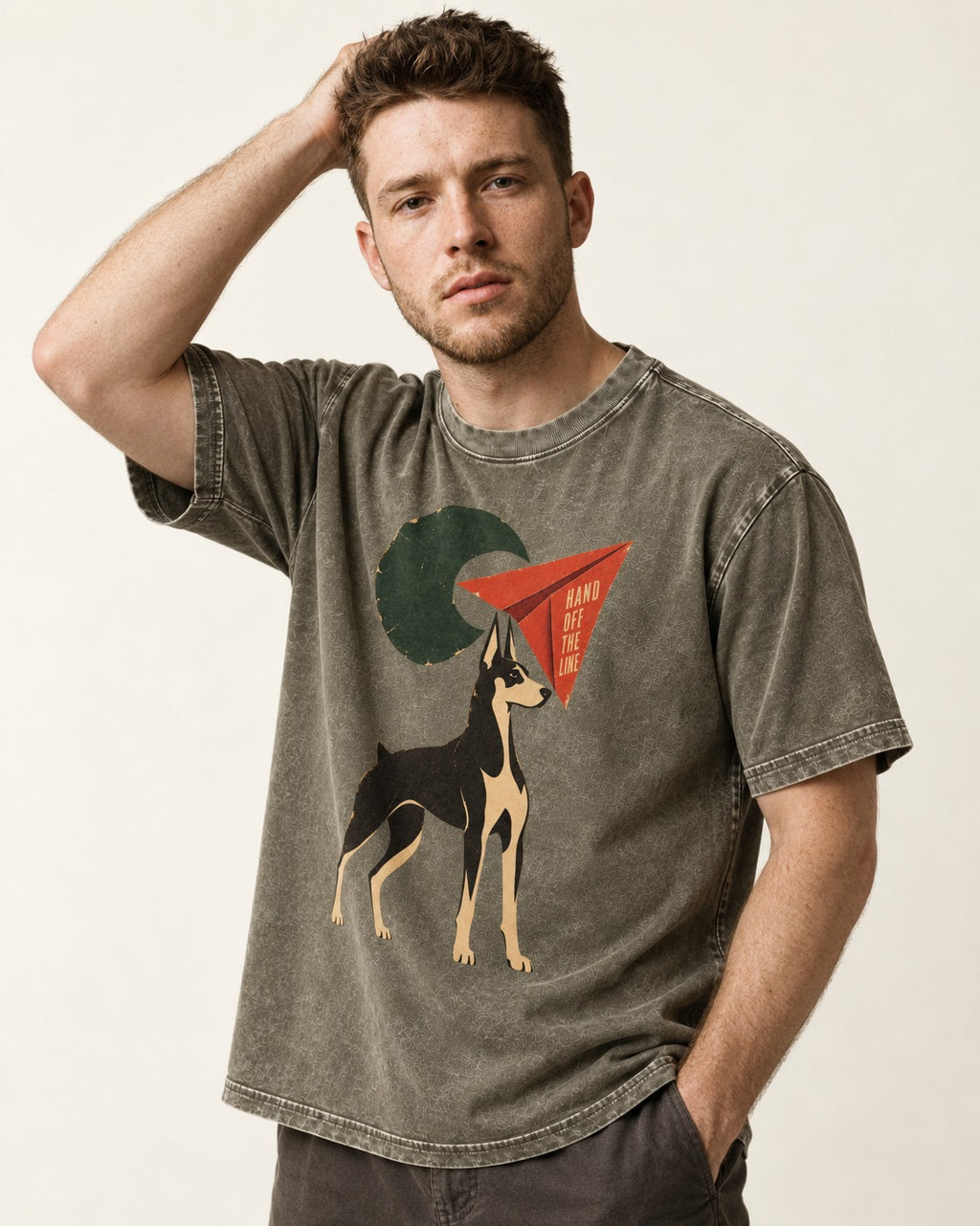 Doberman Hand Off the Line Paper Plane Graphic Washed Tee in Army Green, worn by a model