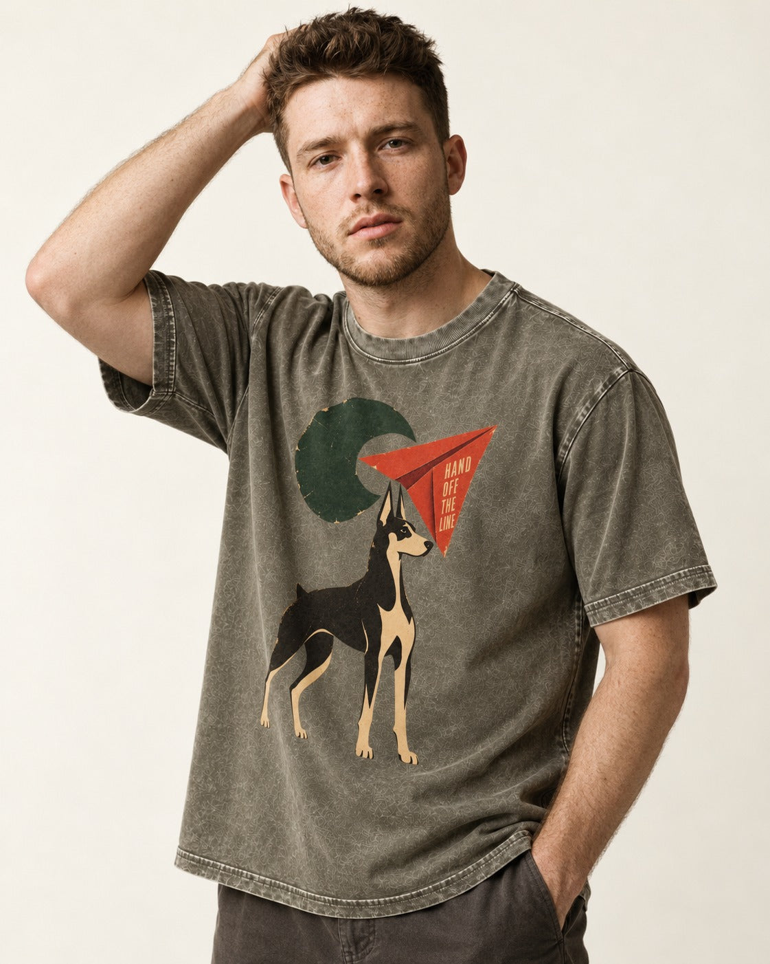 Doberman Hand Off the Line Paper Plane Graphic Washed Tee in Army Green, worn by a model