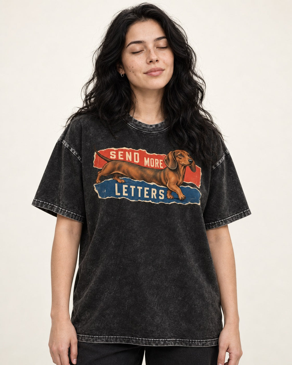 Dachshund Send More Letters Torn Paper Graphic Washed Tee in Black, worn by a model