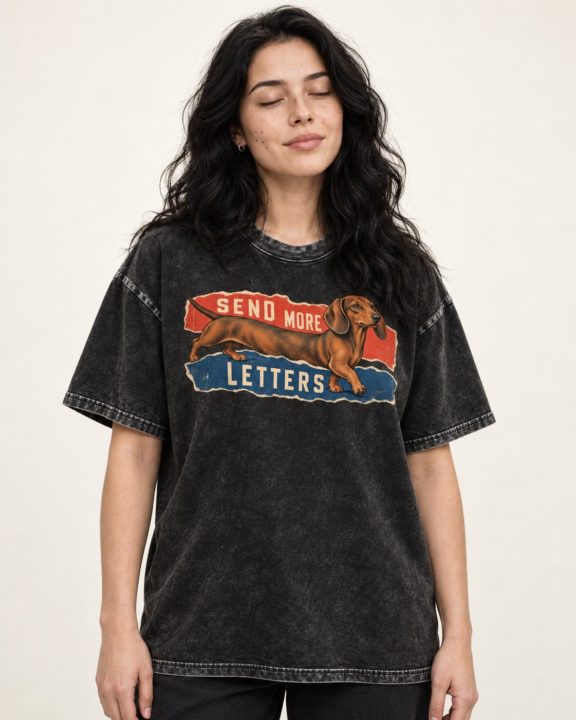 Dachshund Send More Letters Torn Paper Graphic Washed Tee in Black, worn by a model