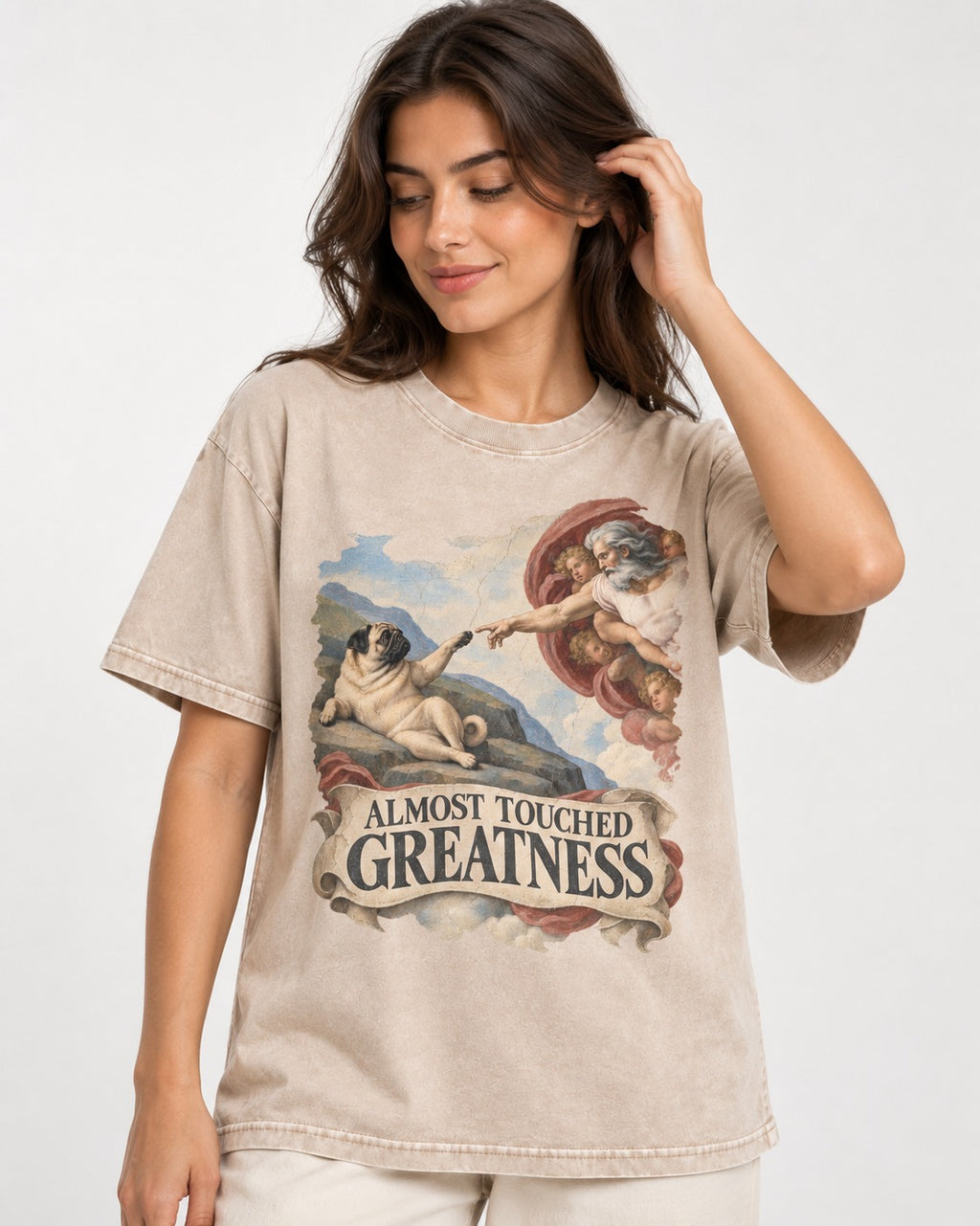 Pug Almost Touched Greatness Creation Parody Graphic Washed Tee in Apricot, worn by a model