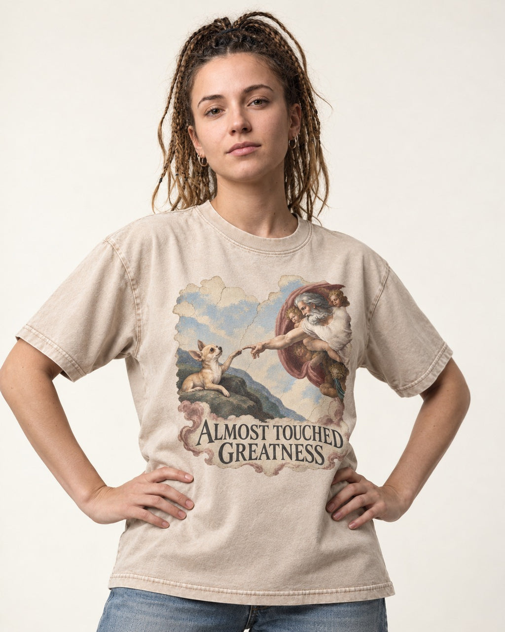 Chihuahua Almost Touched Greatness Renaissance Parody Washed Tee in Apricot, worn by a model