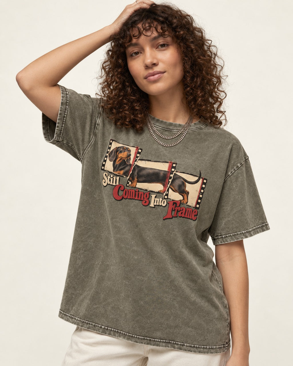 Dachshund Still Coming Into Frame Vintage Filmstrip Graphic Washed Tee in Army Green, worn by a model