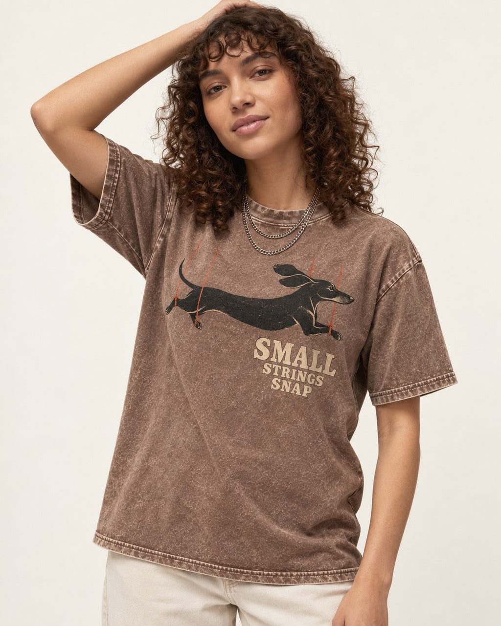 Dachshund Small Strings Snap Marionette Graphic Washed Tee in Coffee, worn by a model