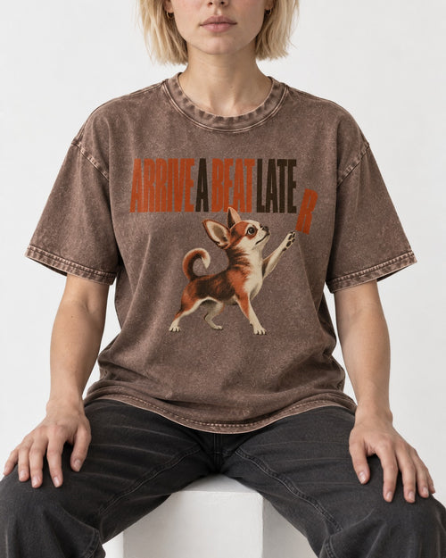 Arrive a Beat Later Chihuahua Washed Tee in Coffee, worn by a seated model