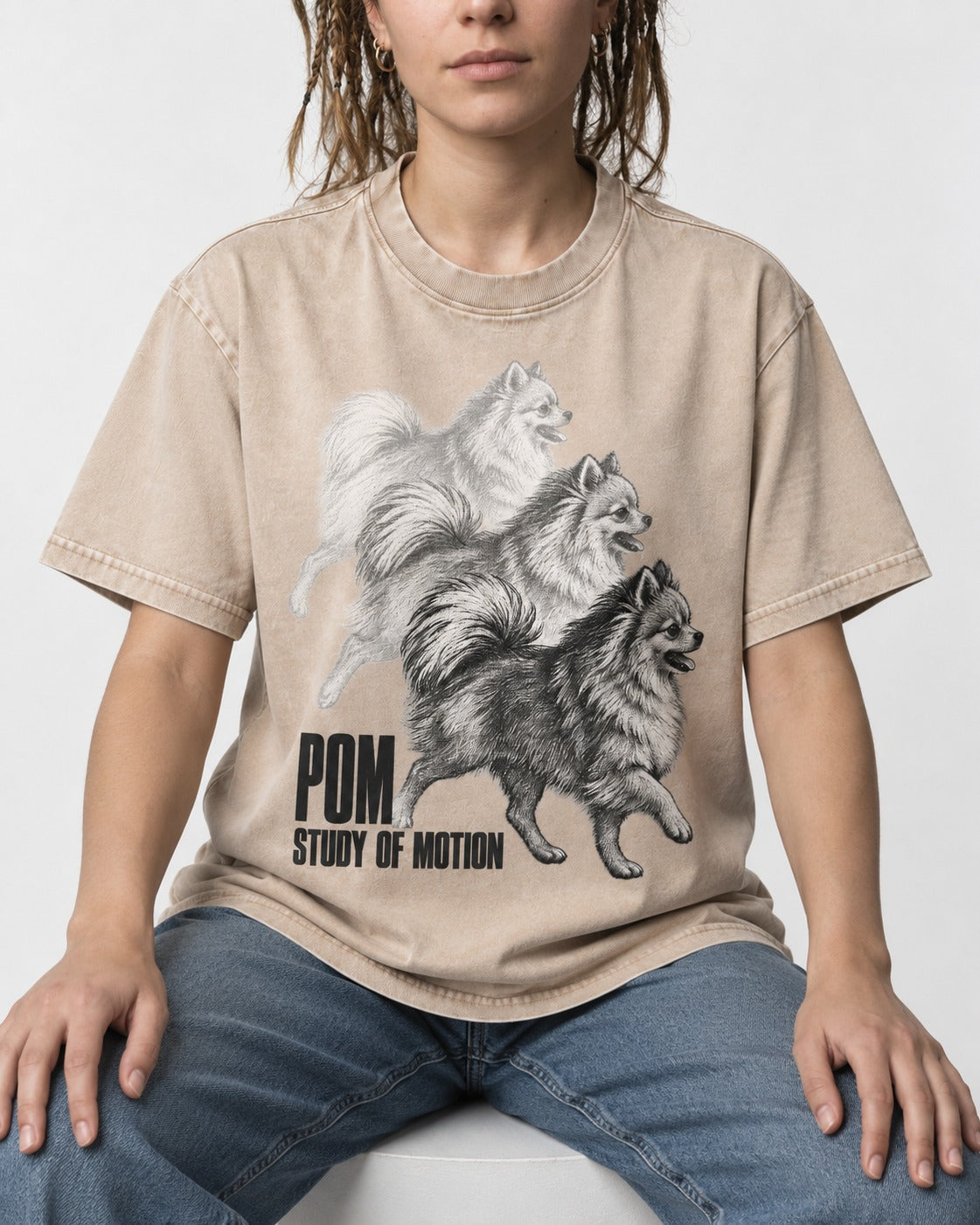 Pomeranian Study of Motion Washed Tee in Apricot, worn by a seated model