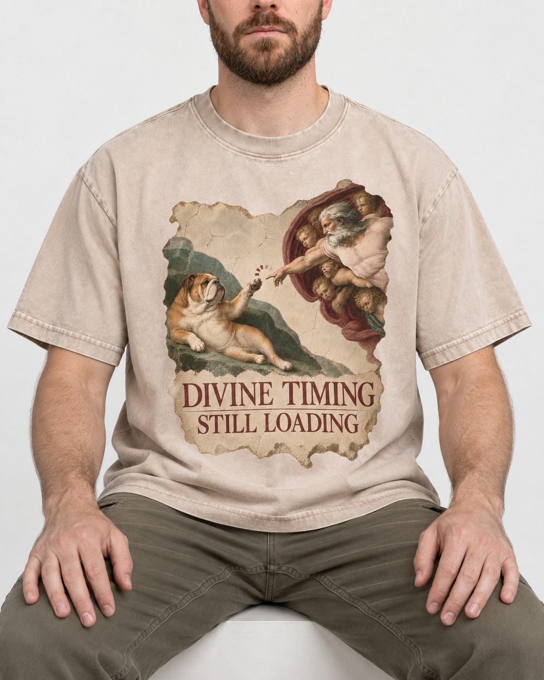 English Bulldog Divine Timing Still Loading Washed Tee in Apricot, worn by a seated model