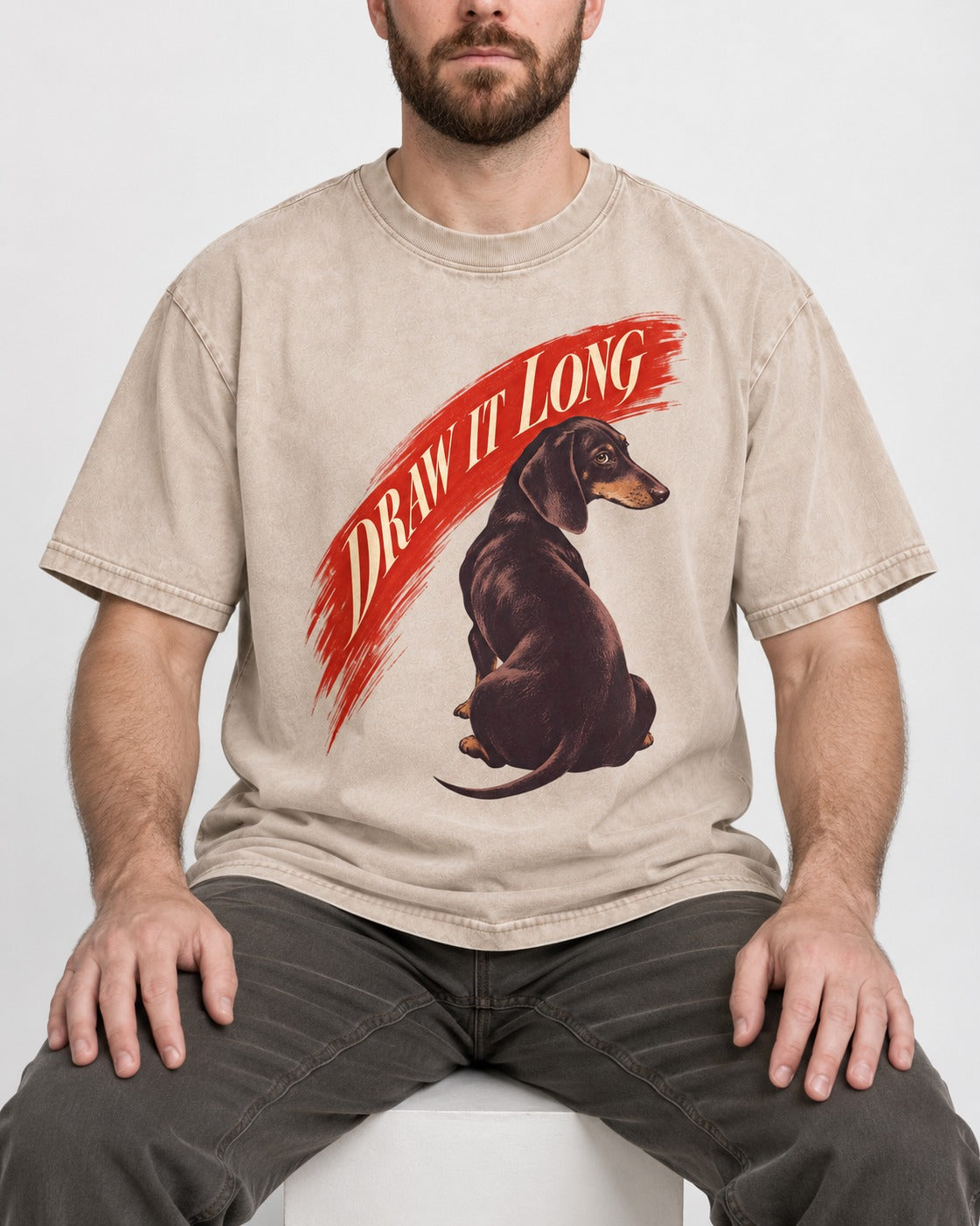 Draw It Long Dachshund Washed Tee in Apricot, worn by a seated model