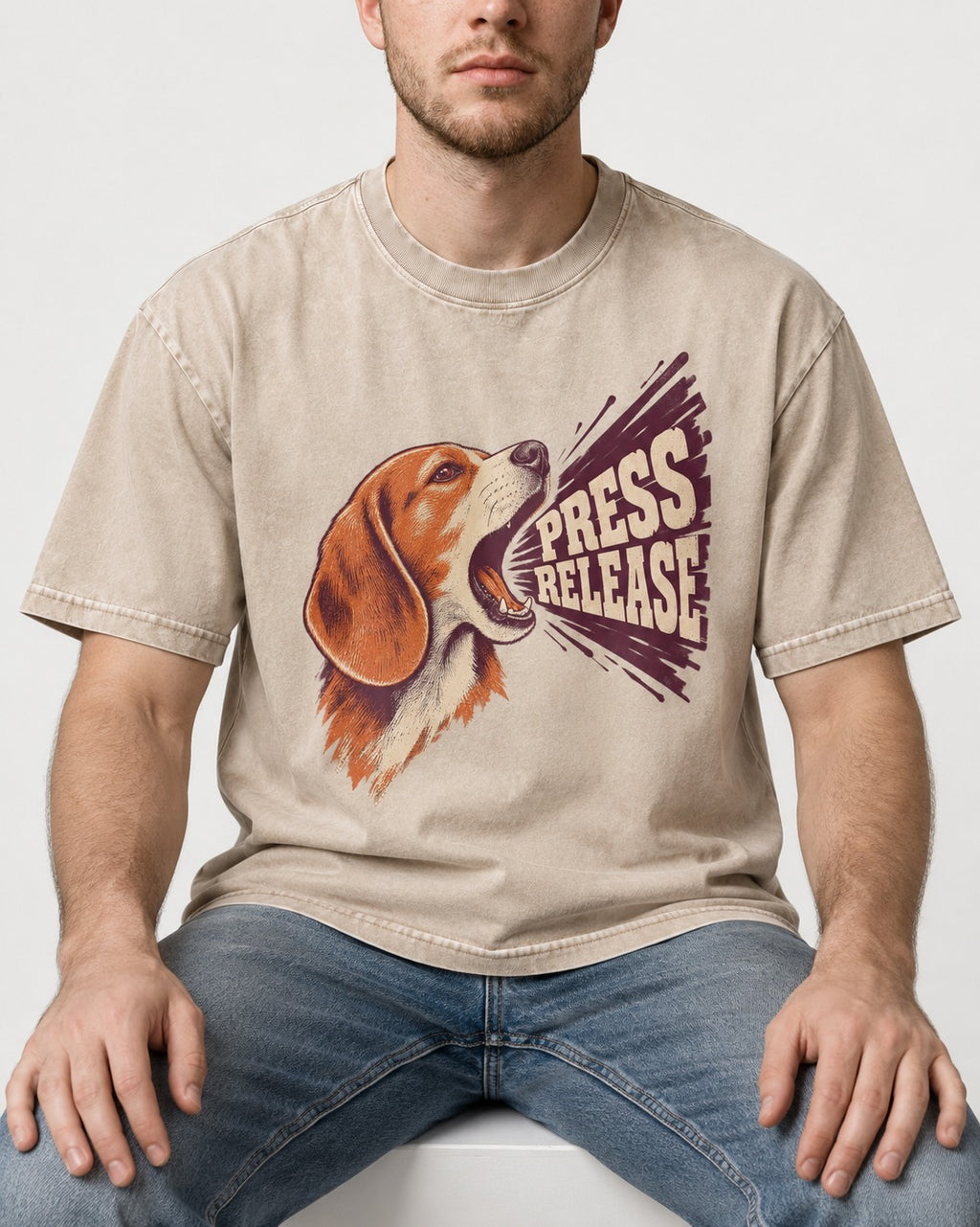 Beagle Press Release Washed Tee in Apricot, worn by a seated model