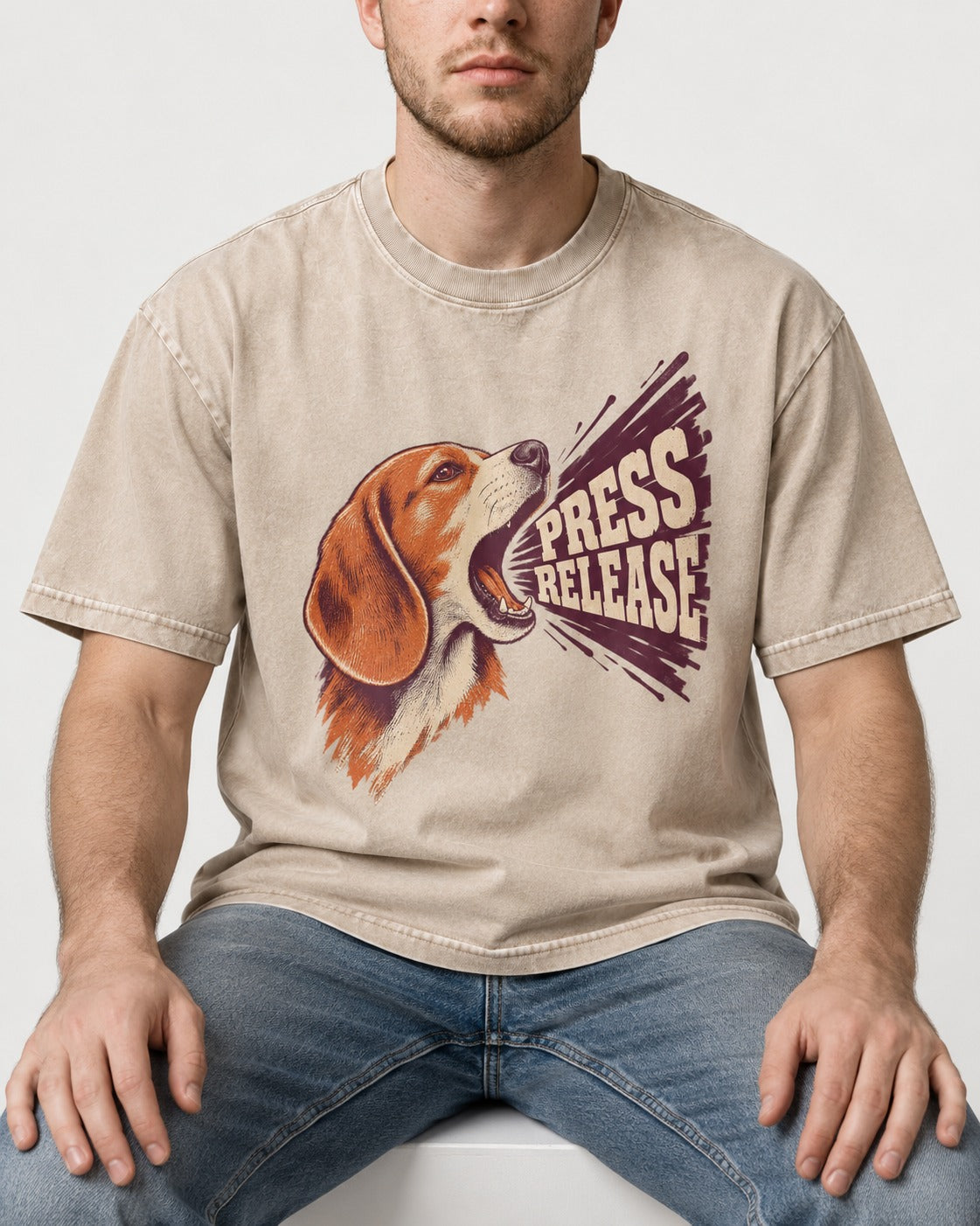 Beagle Press Release Washed Tee in Apricot, worn by a seated model