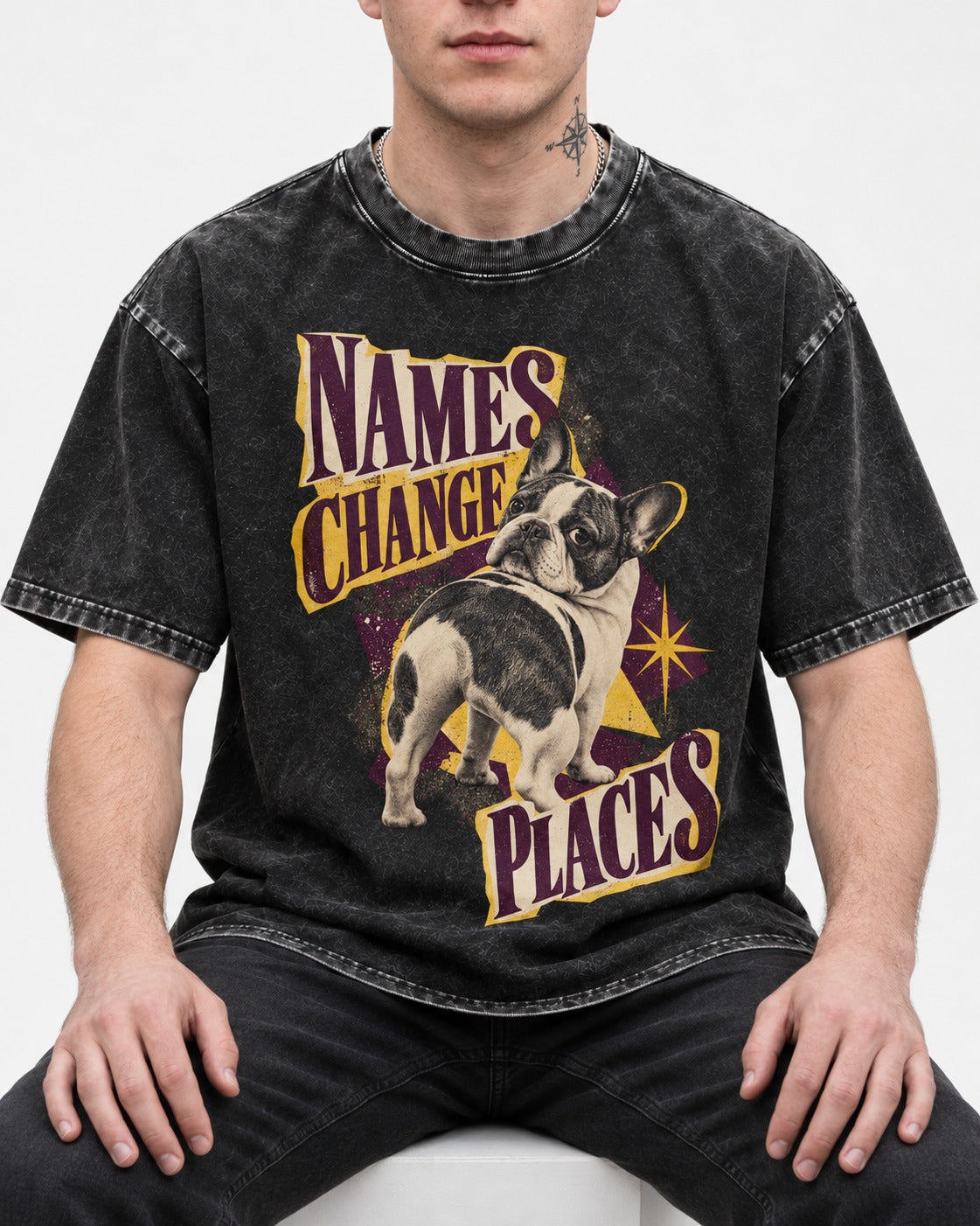 Frenchie Names Change Places Purple Poster Graphic Washed Tee in Black, worn by a seated model