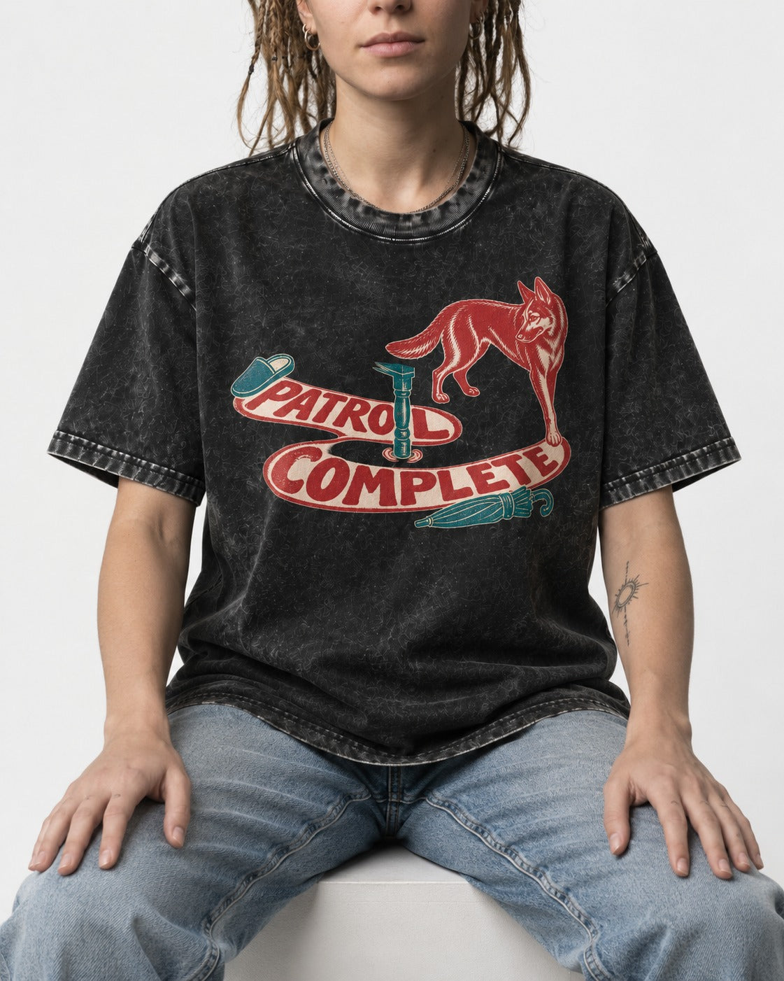 German Shepherd Dog Patrol Complete Umbrella Graphic Washed Tee in Black, worn by a seated model