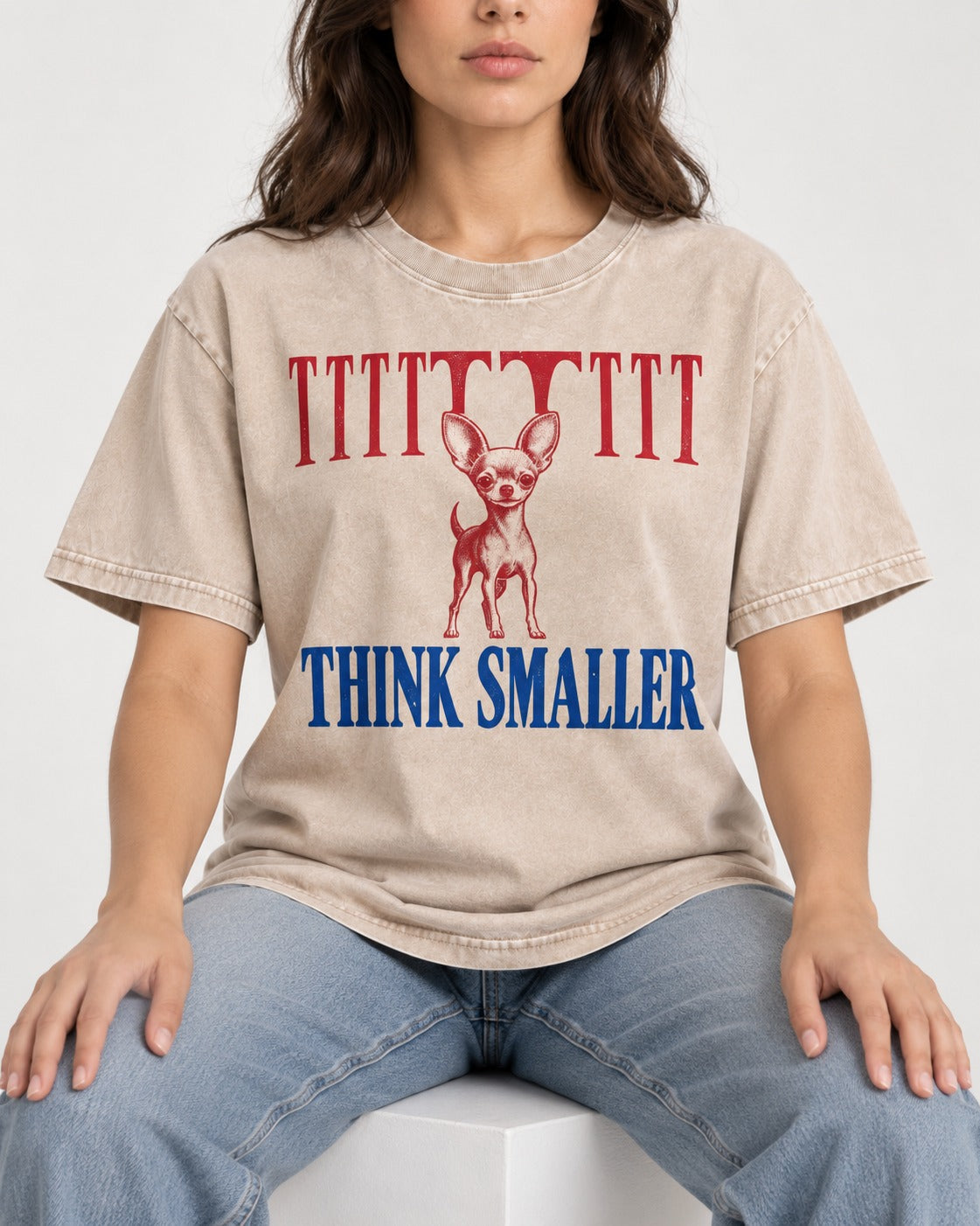 Think Smaller Chihuahua Washed Tee in Apricot, worn by a seated model