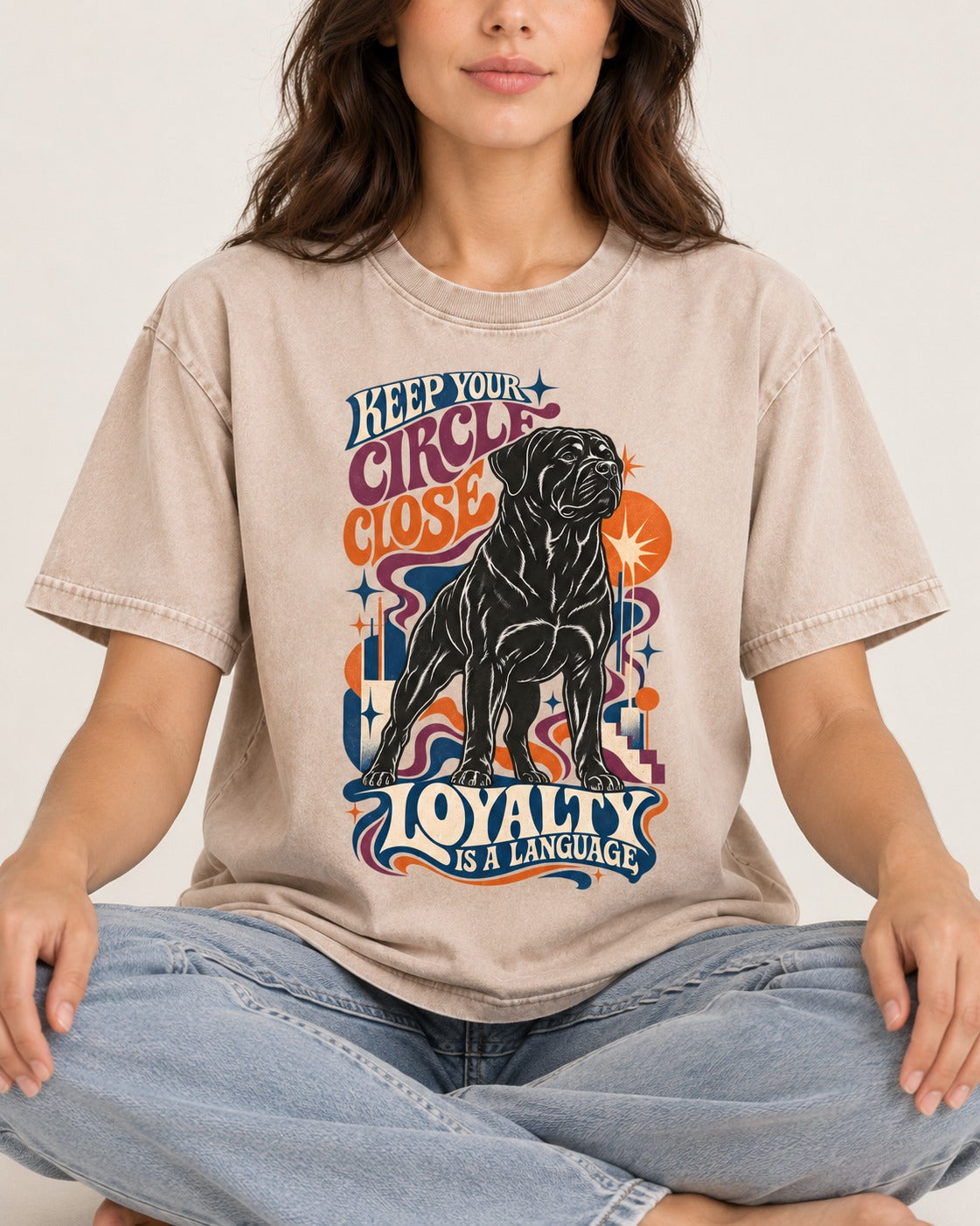 Keep Your Rottweiler Circle Close Washed Tee in Apricot, worn by a seated model