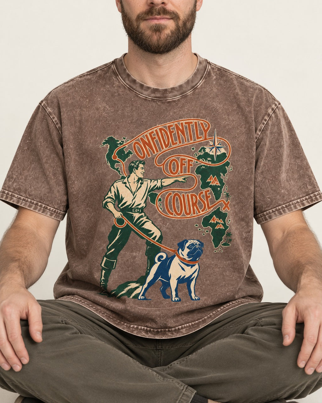 Pug Confidently Off Course Washed Tee in Coffee, worn by a seated model