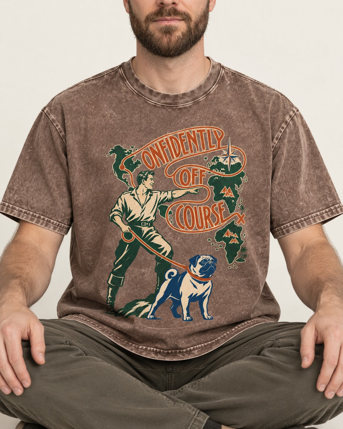 Pug Confidently Off Course Washed Tee in Coffee, worn by a seated model